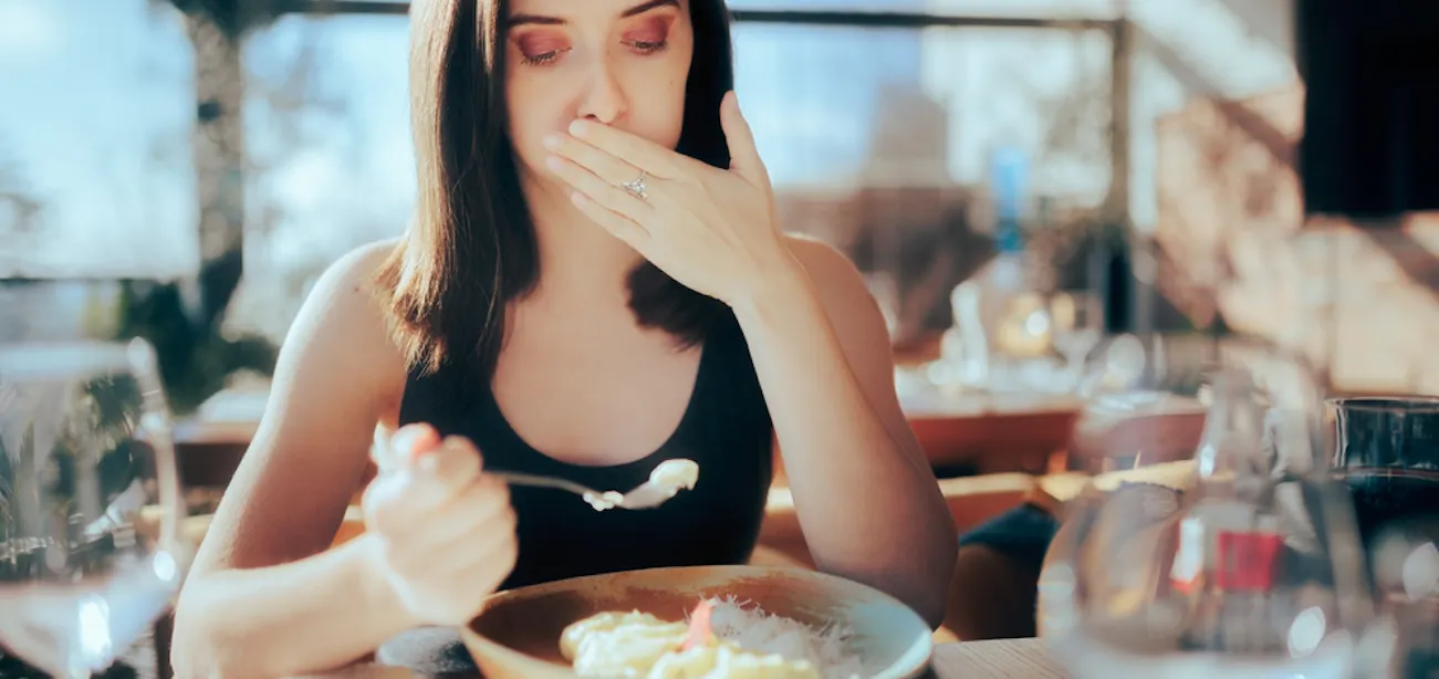 A lady having a sulphur burp while eating