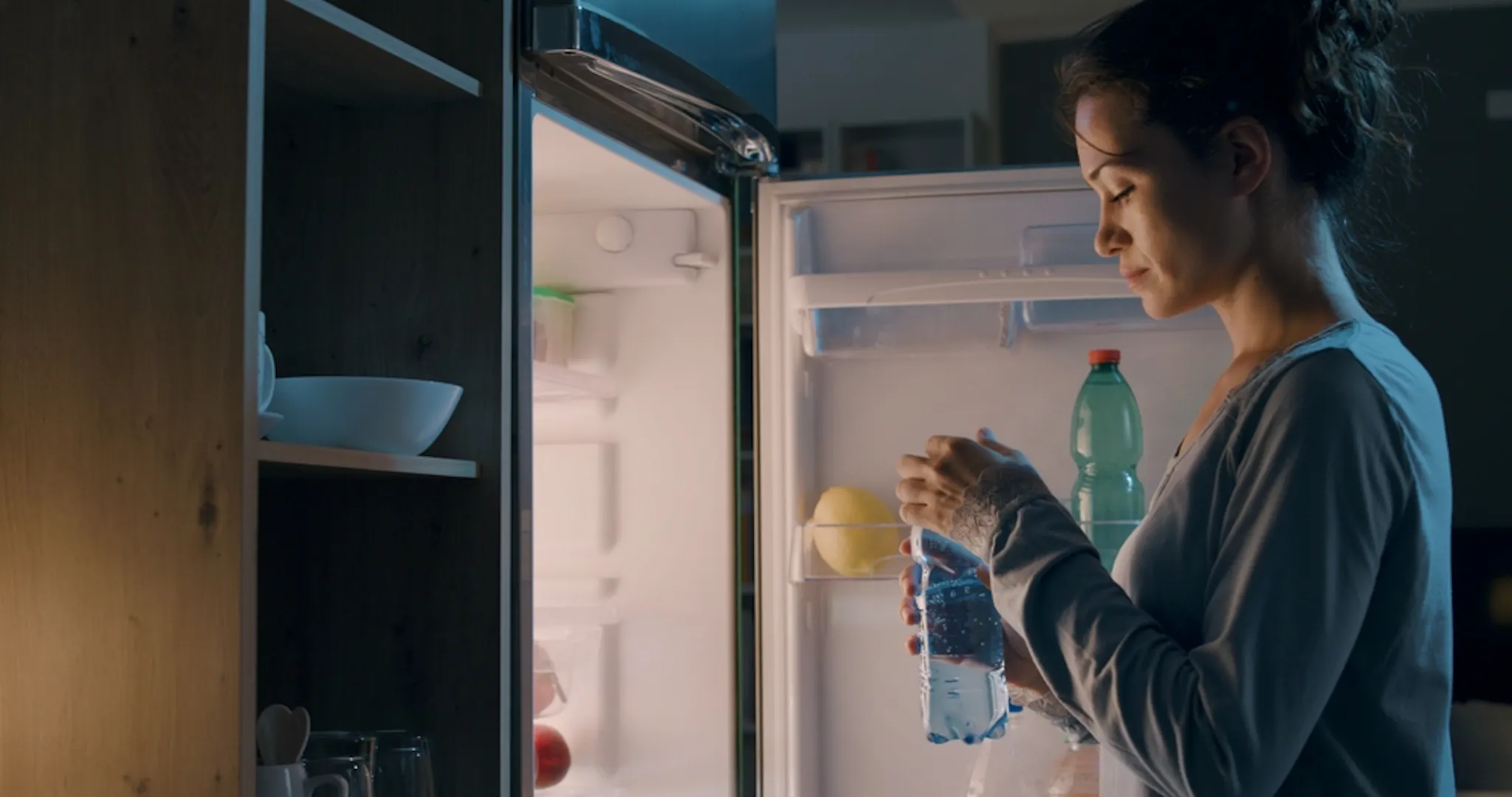 A person Drinking water at night to break late night eating habit
