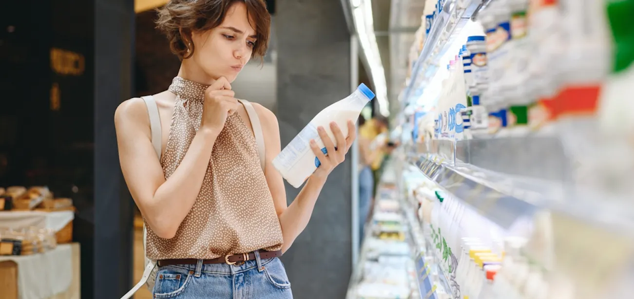 A lady checking a can of unsweetened coconut milk