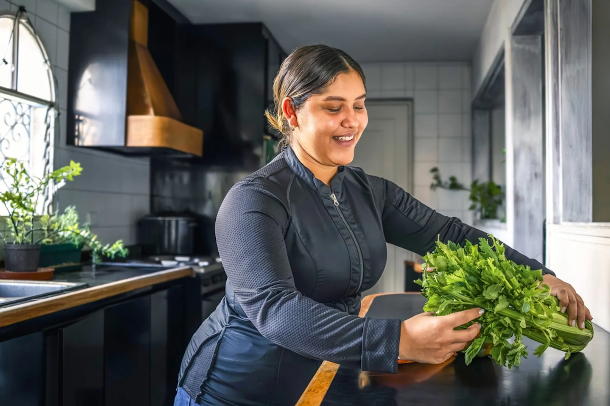 Lady having green leafy vegetables for folate
