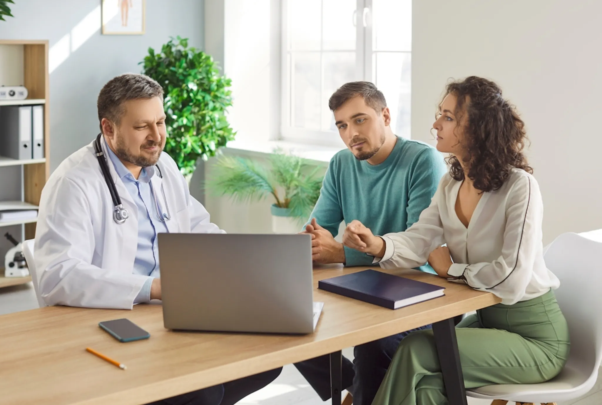 Doctor showing a patient showing thyroid hormone production, T4 to T3 conversion, and pituitary feedback loop