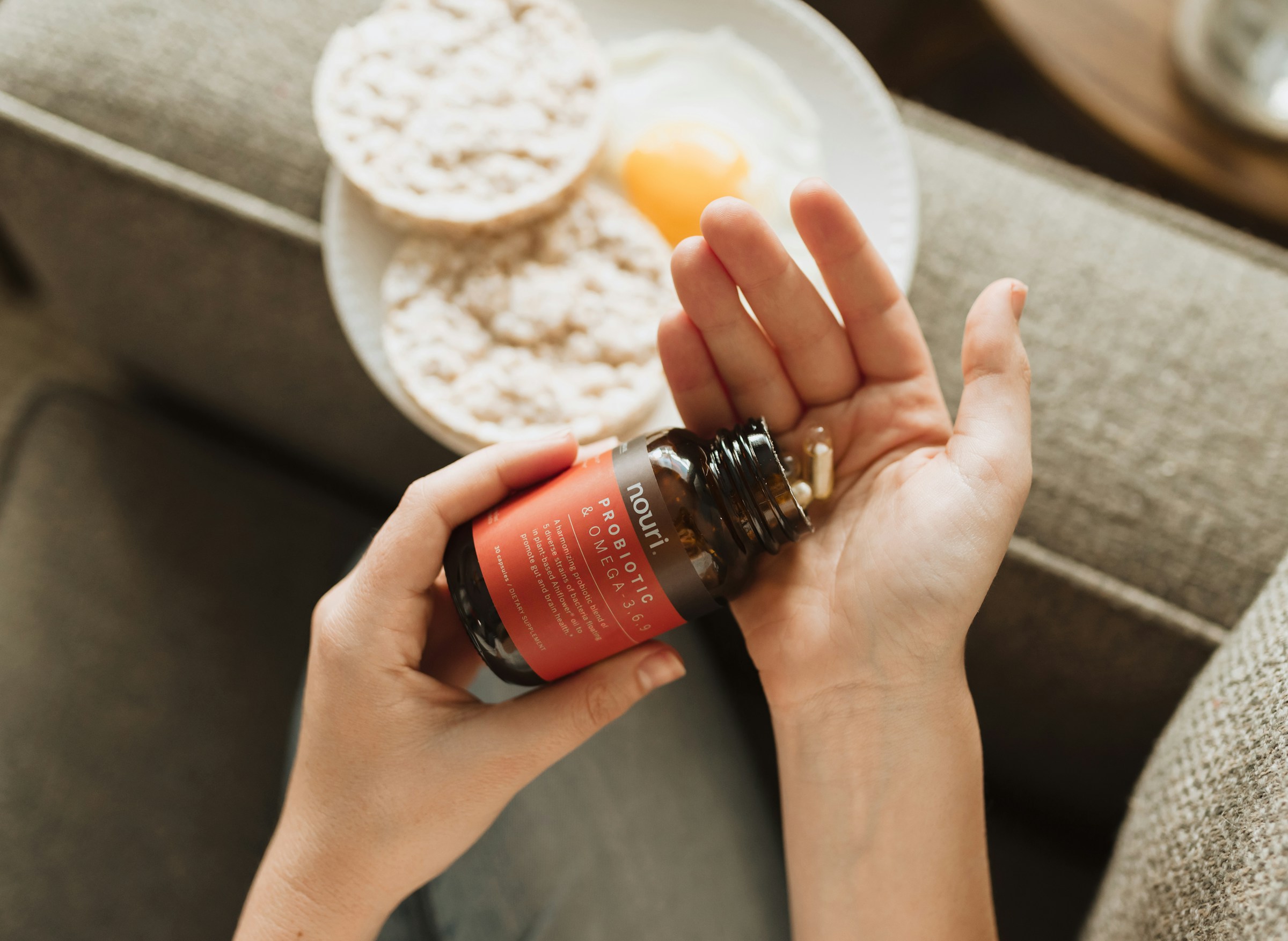 Person experiencing abdominal bloating taking digestive enzyme