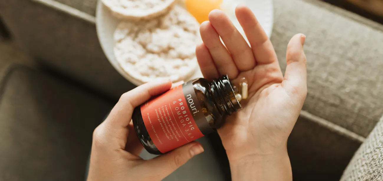 Person experiencing abdominal bloating taking digestive enzyme