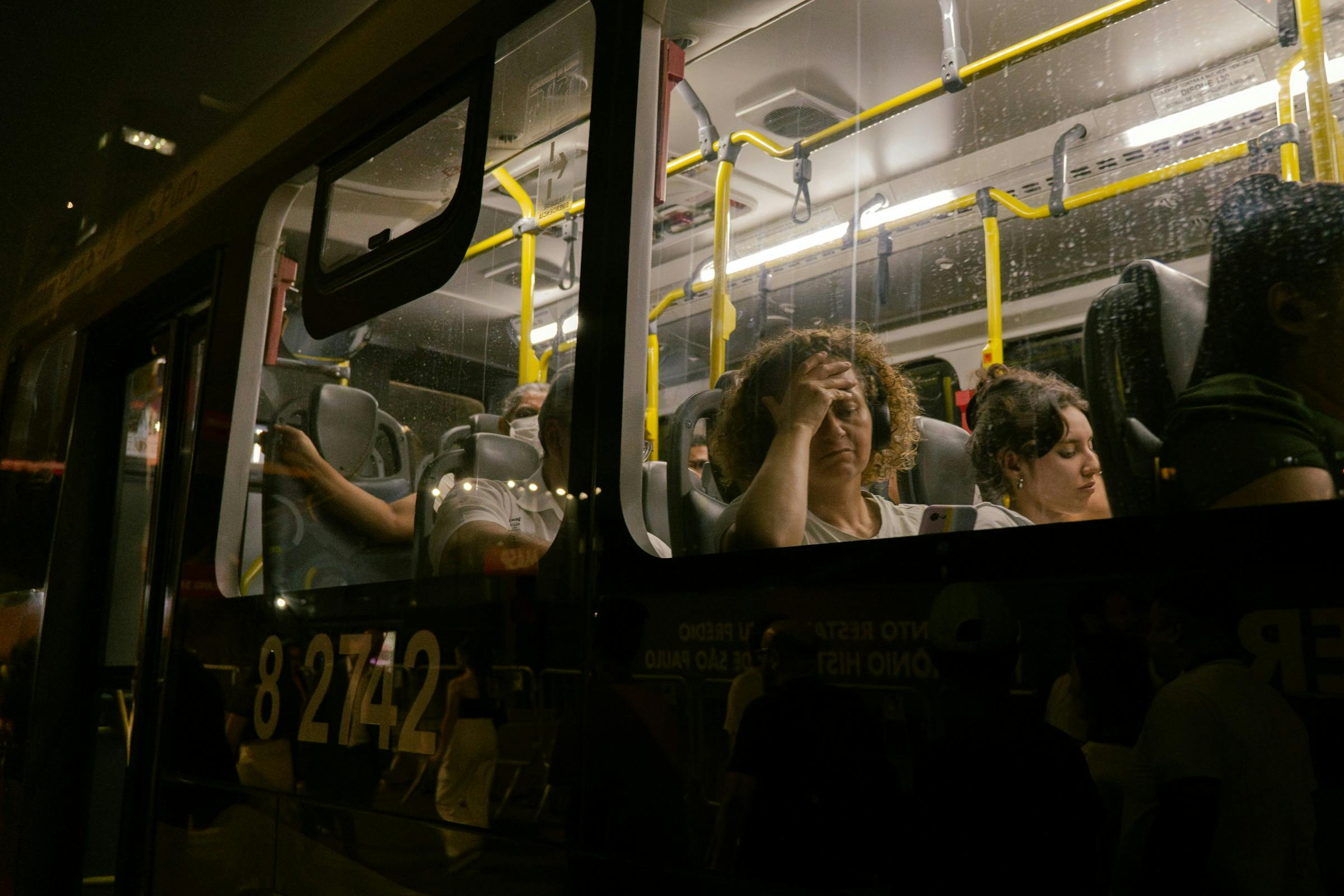 Woman feeling tired in a bus, representing menopause fatigue and low energy