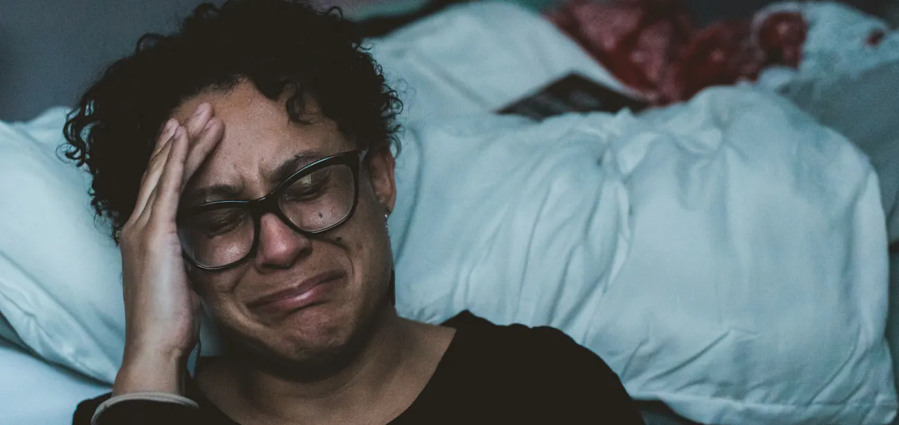 Woman in midlife tired in her room, representing menopause fatigue and low energy