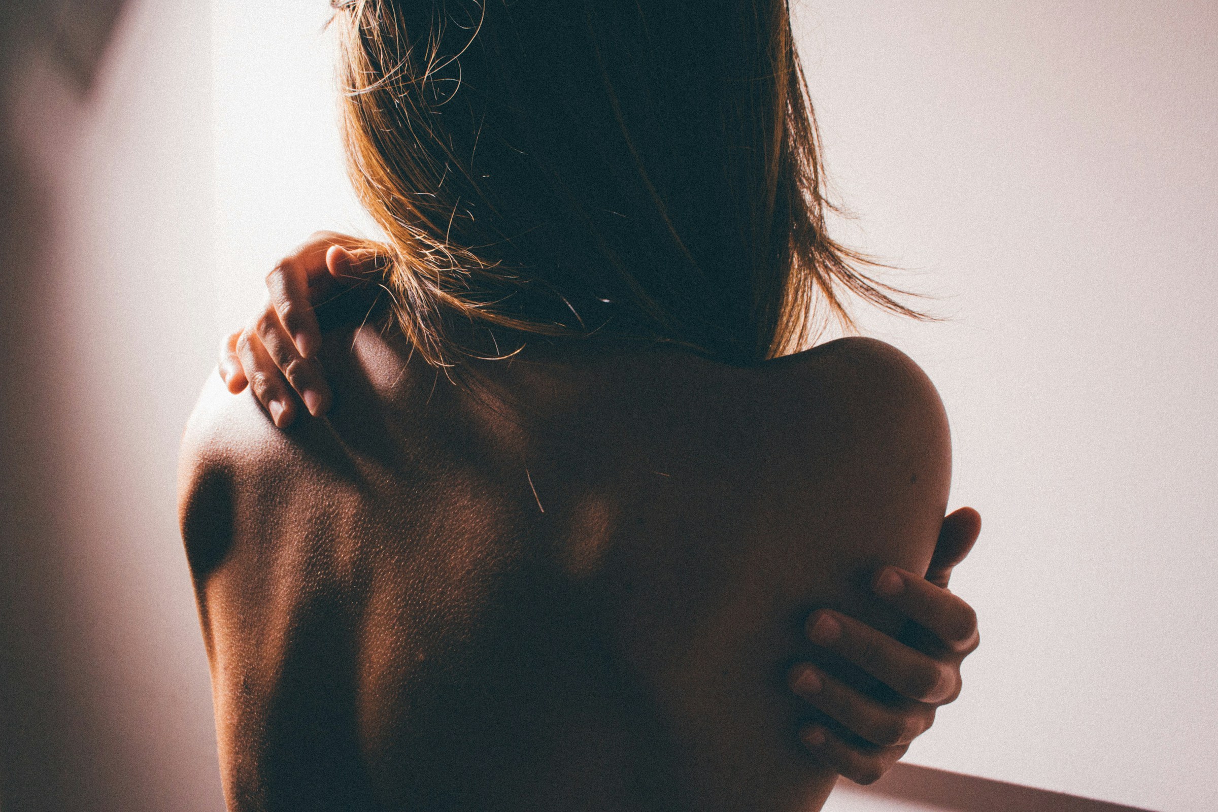 Woman applying moisturizer to dry skin during perimenopause
