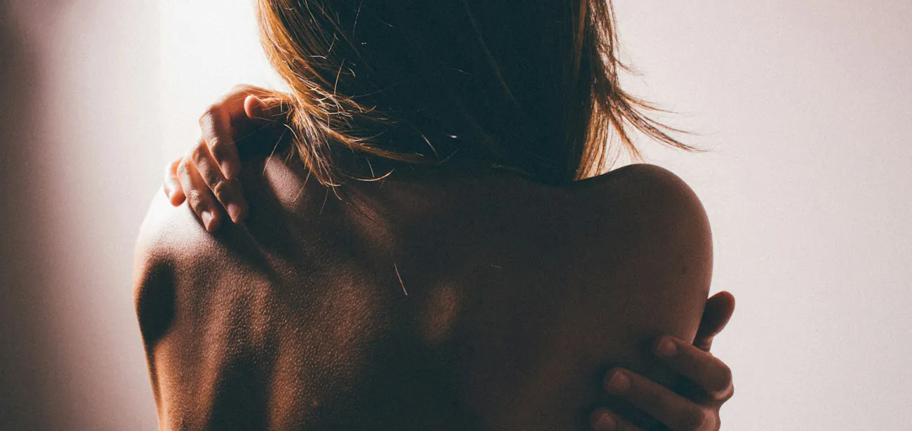 Woman applying moisturizer to dry skin during perimenopause