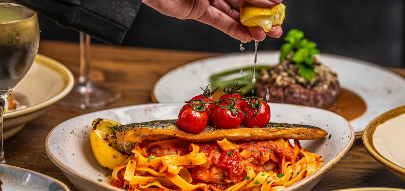Mediterranean diet plate with olive oil, vegetables, and fish for metabolic syndrome