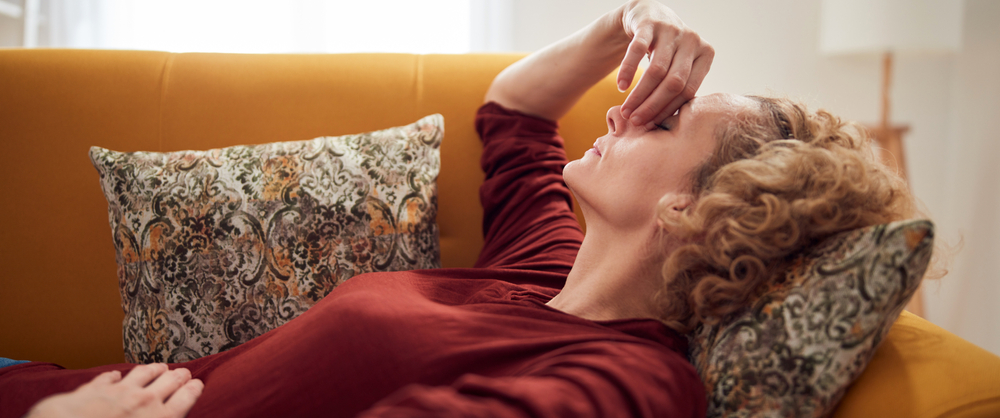 A lady experiencing cramps during menopause