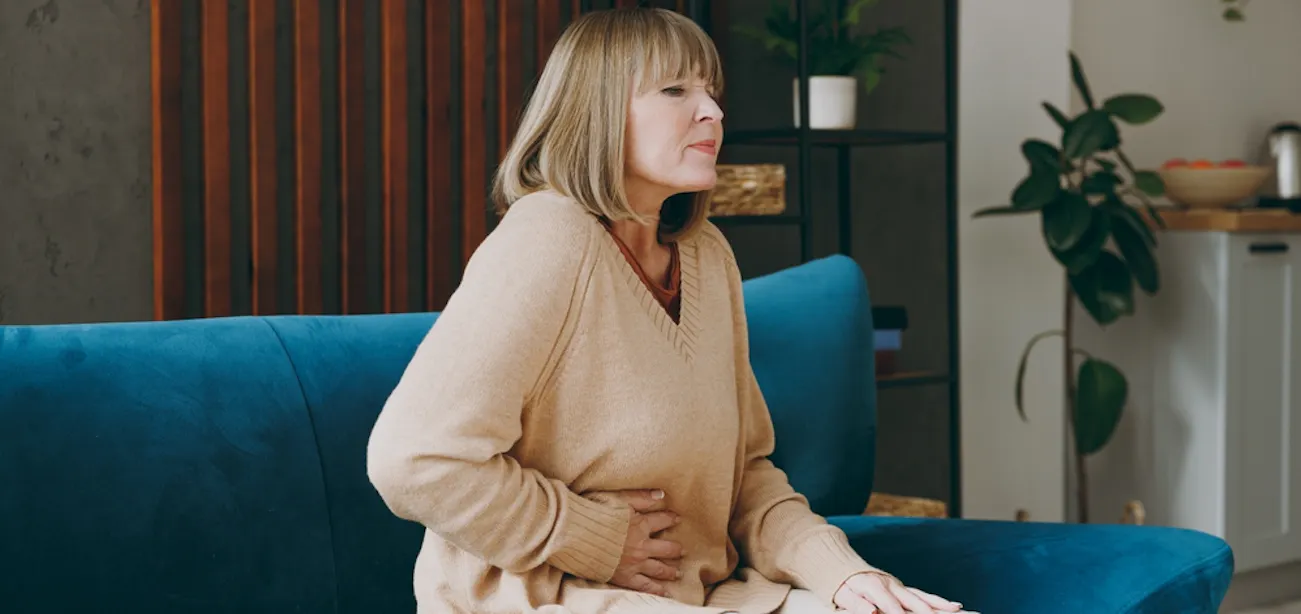 A lady feeling bloated after a meal