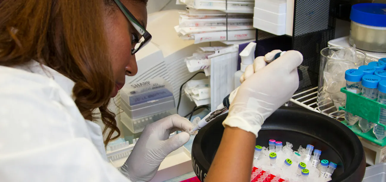 A lab vial and blood test results on a clinical desk, representing GLP-1 biomarker monitoring for patients on semaglutide or tirzepatide therapy.