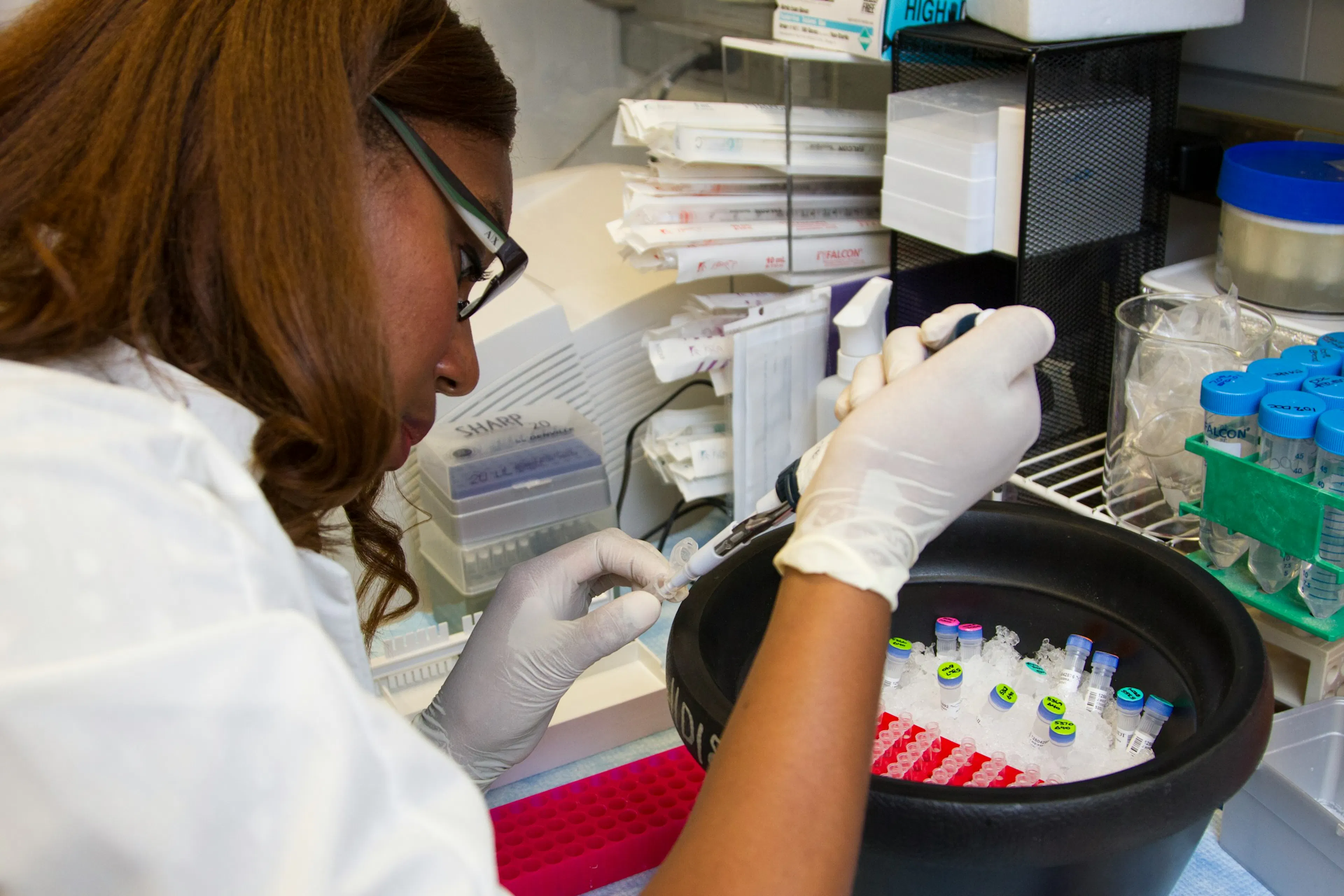 A lab vial and blood test results on a clinical desk, representing GLP-1 biomarker monitoring for patients on semaglutide or tirzepatide therapy.