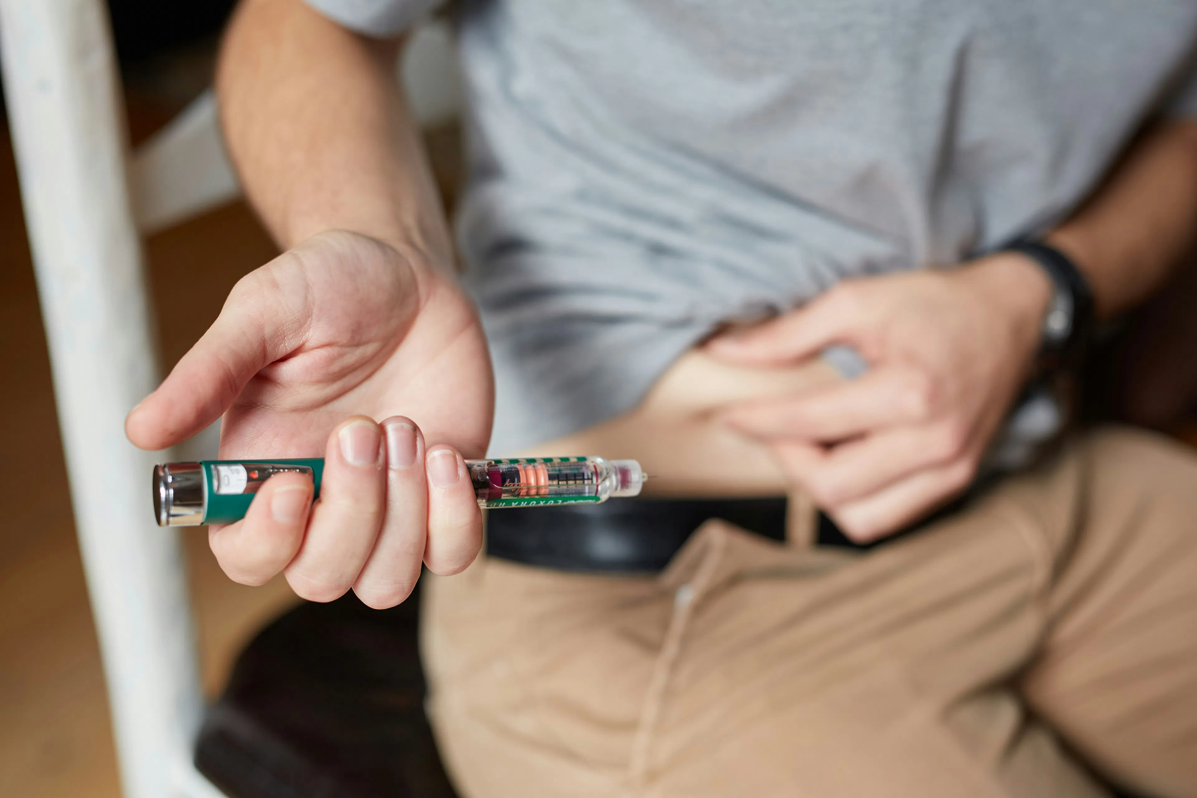 Image of a person administering a GLP-1 peptide injection