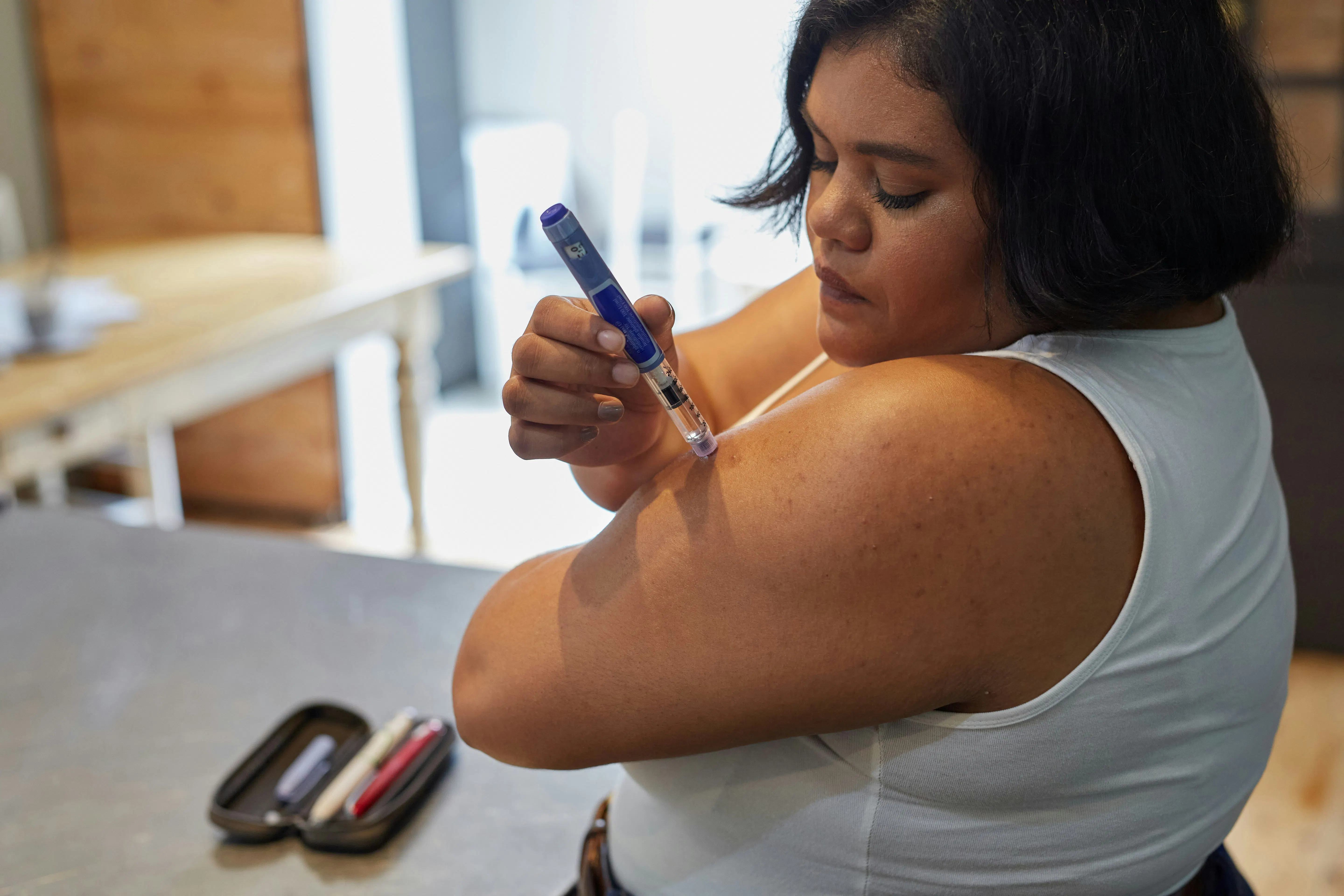 A lady checking how to inject peptides at home