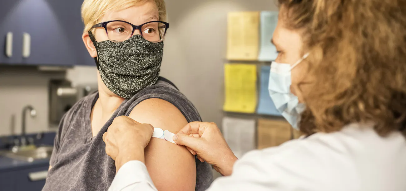A woman in an appointment reviewing her PCOS hormonal panel results with a clinician