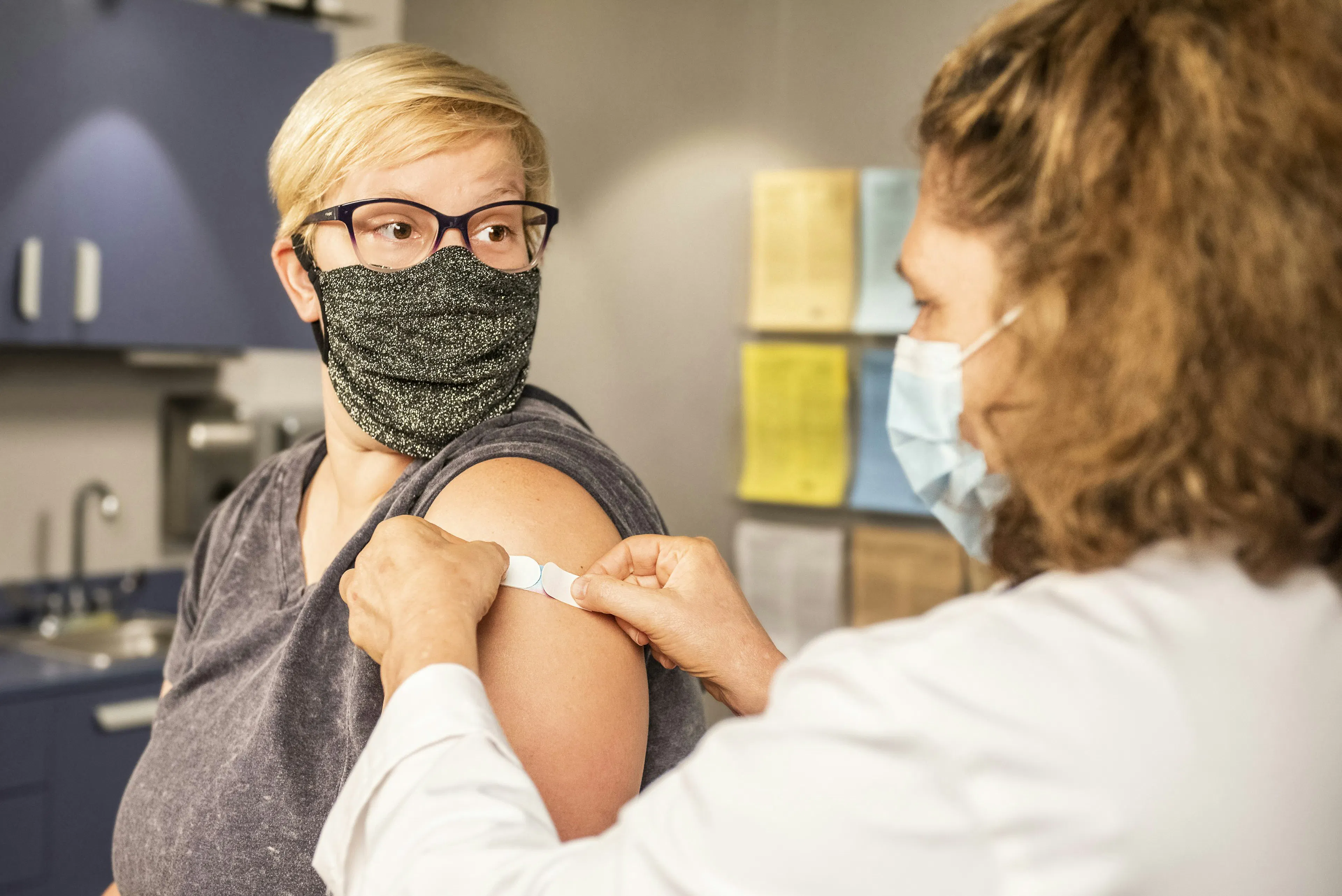 A woman in an appointment reviewing her PCOS hormonal panel results with a clinician