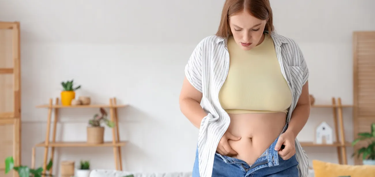 An image of a lady concerned about her belly fat