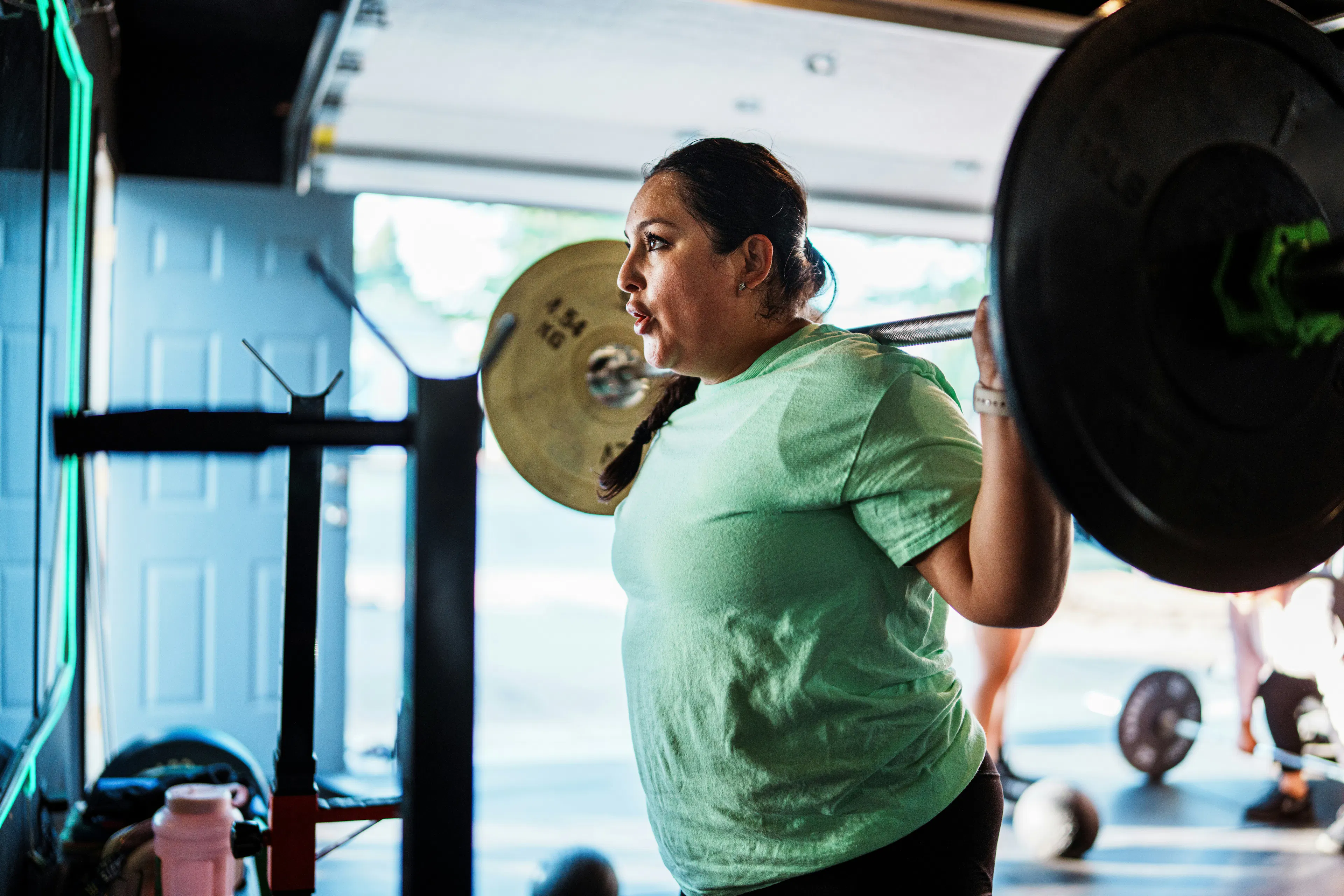 An image of a lady working out and using CJC-1295 Ipamorelin Stack for Fat Loss & Recovery