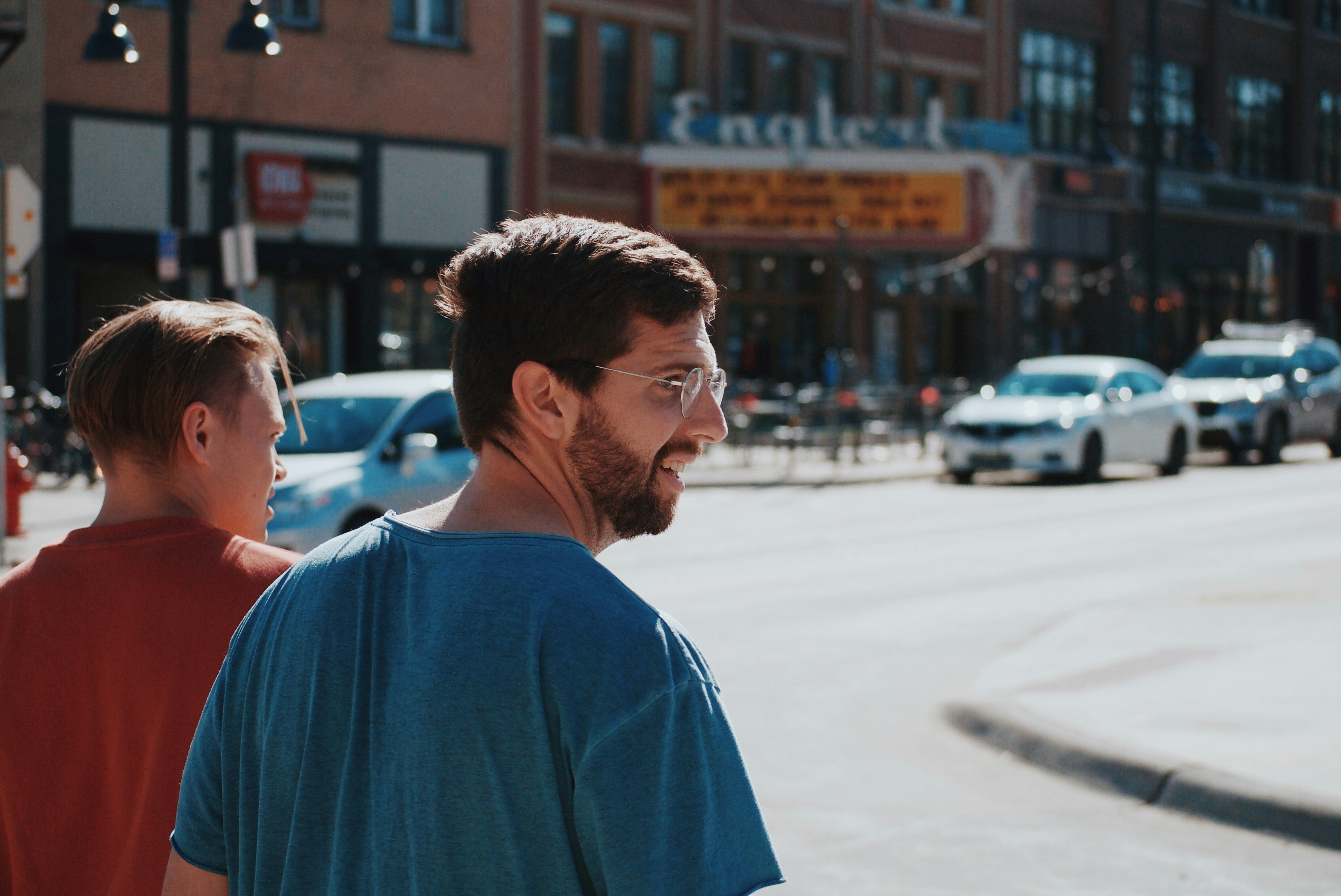 An image showing two adult men walking on the street