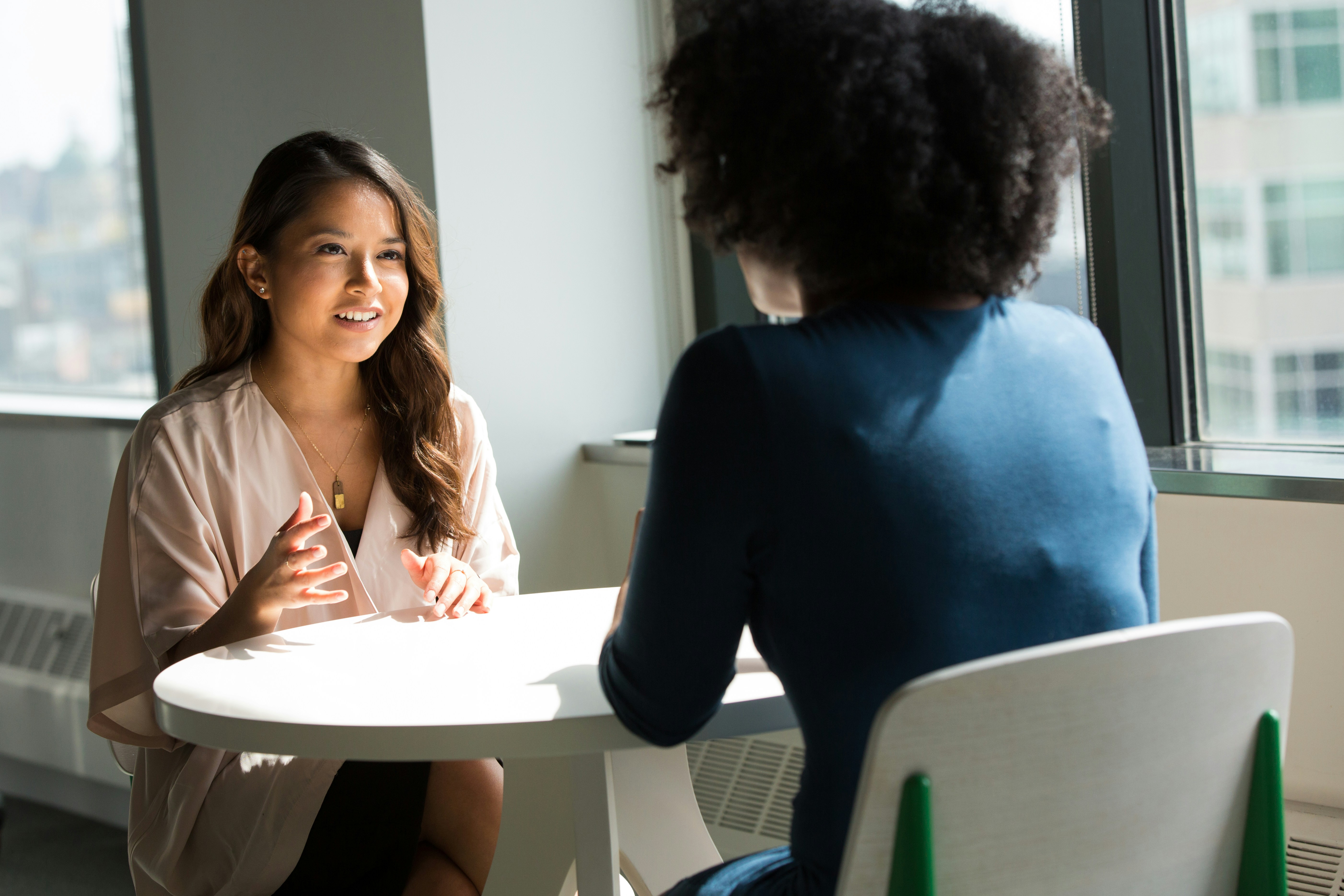 An image showing two ladies discussing categories of peptides