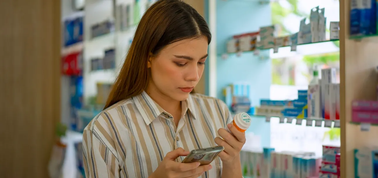 An image showing a person navigating the aisle of a pharmacy to get a peptide drug