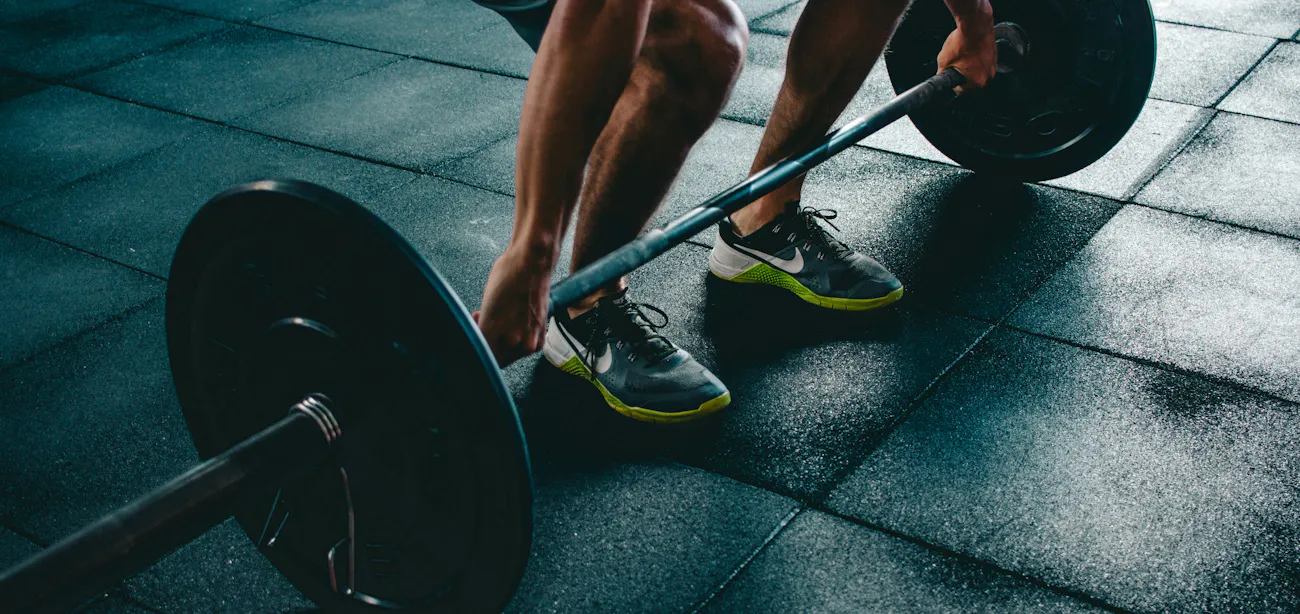 An image showing a person working out in the gym and using TB-500 peptide