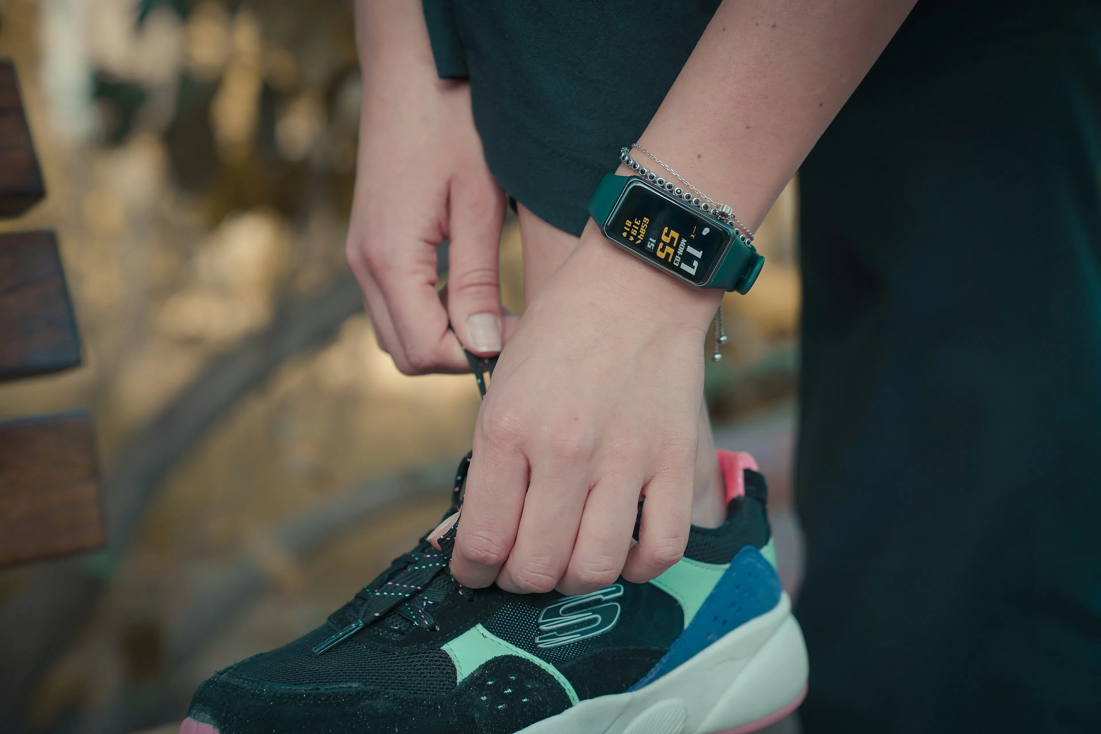 an image showing a woman using a wearable tracker
