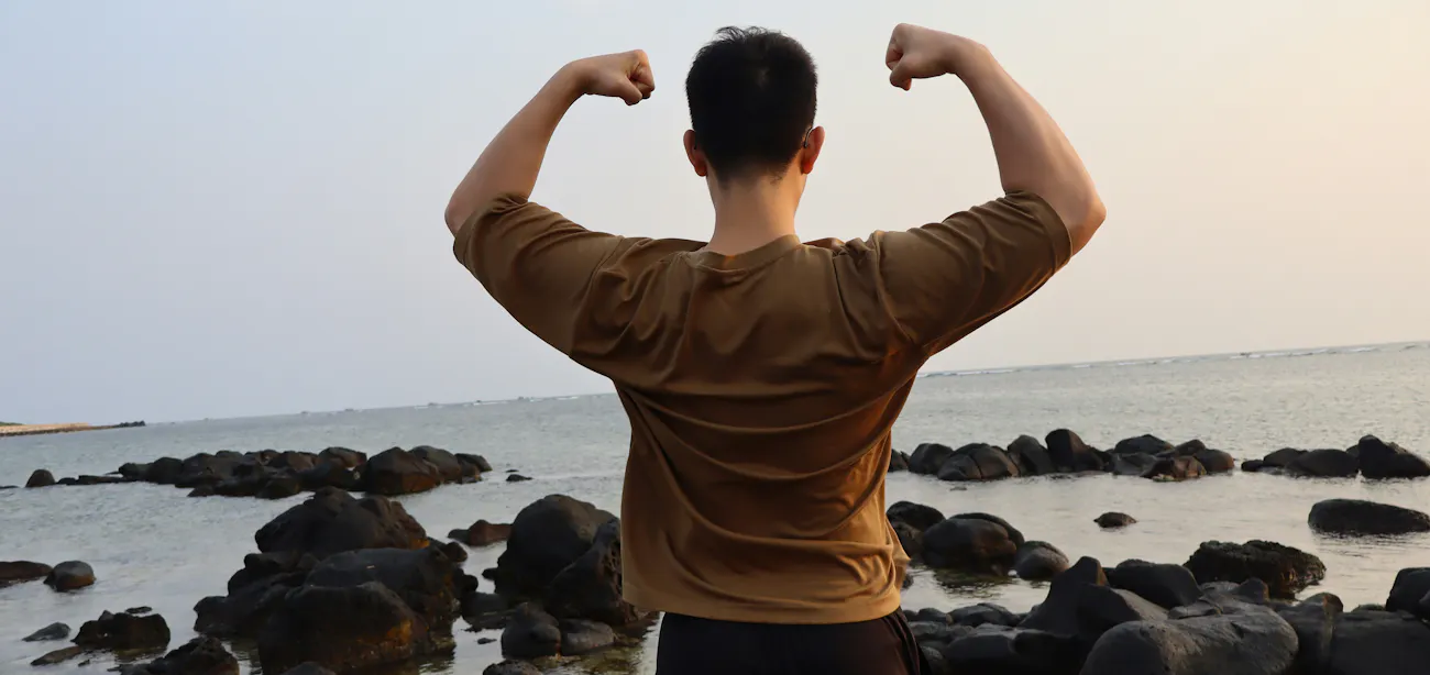 man in his 30s performing resistance training to preserve bone mineral density while on GLP-1 metabolic therapy