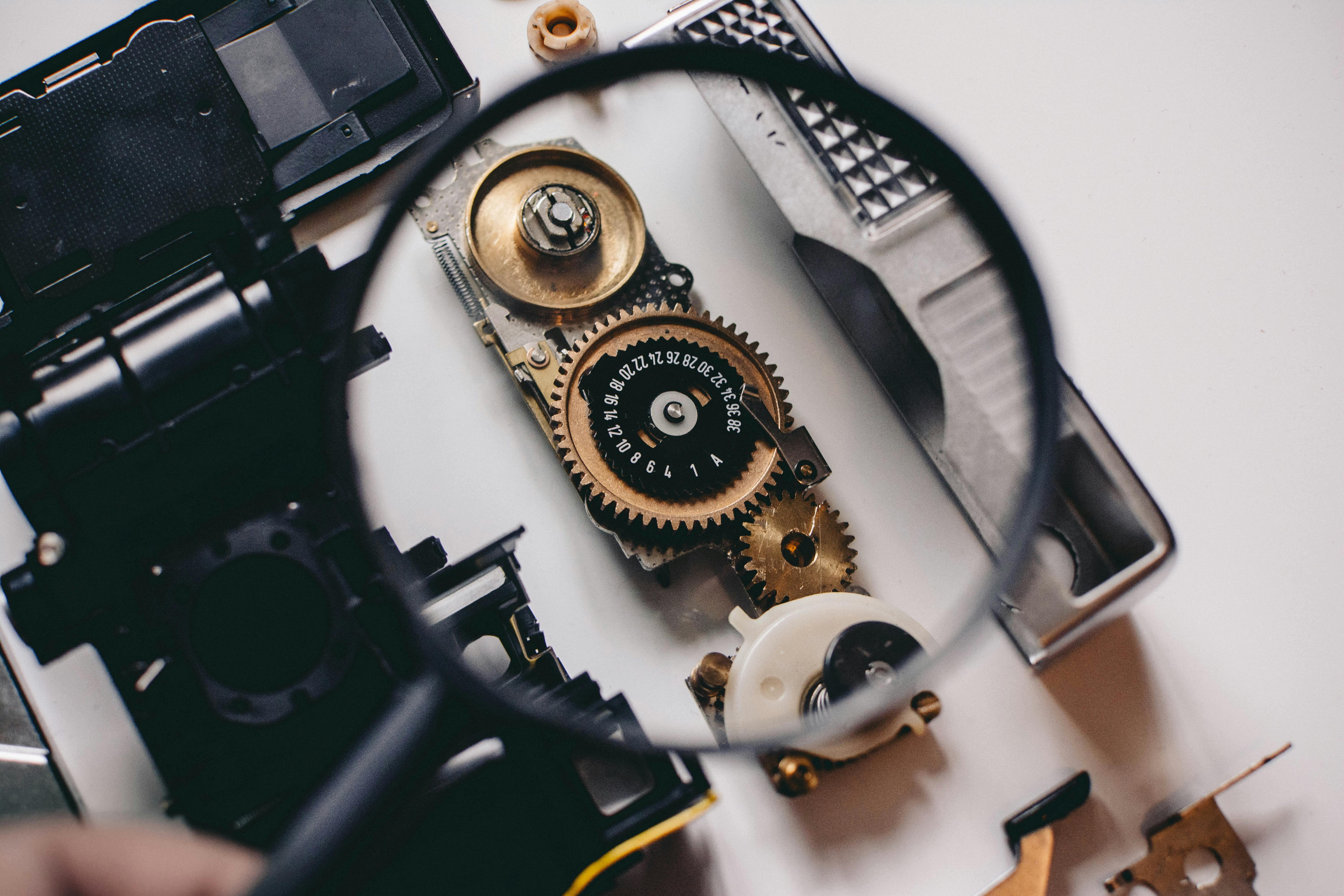 Magnifying glass inspecting mechanical parts