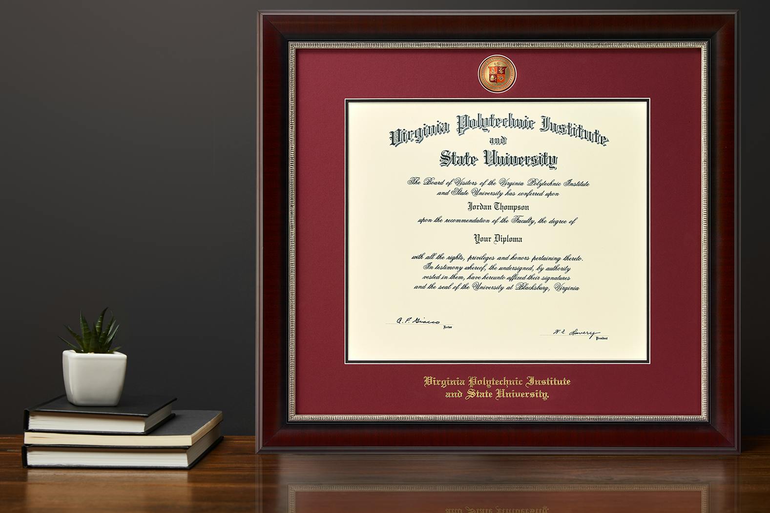 Virginia Tech Diploma Frame  with masterpiece medallion on a desk 