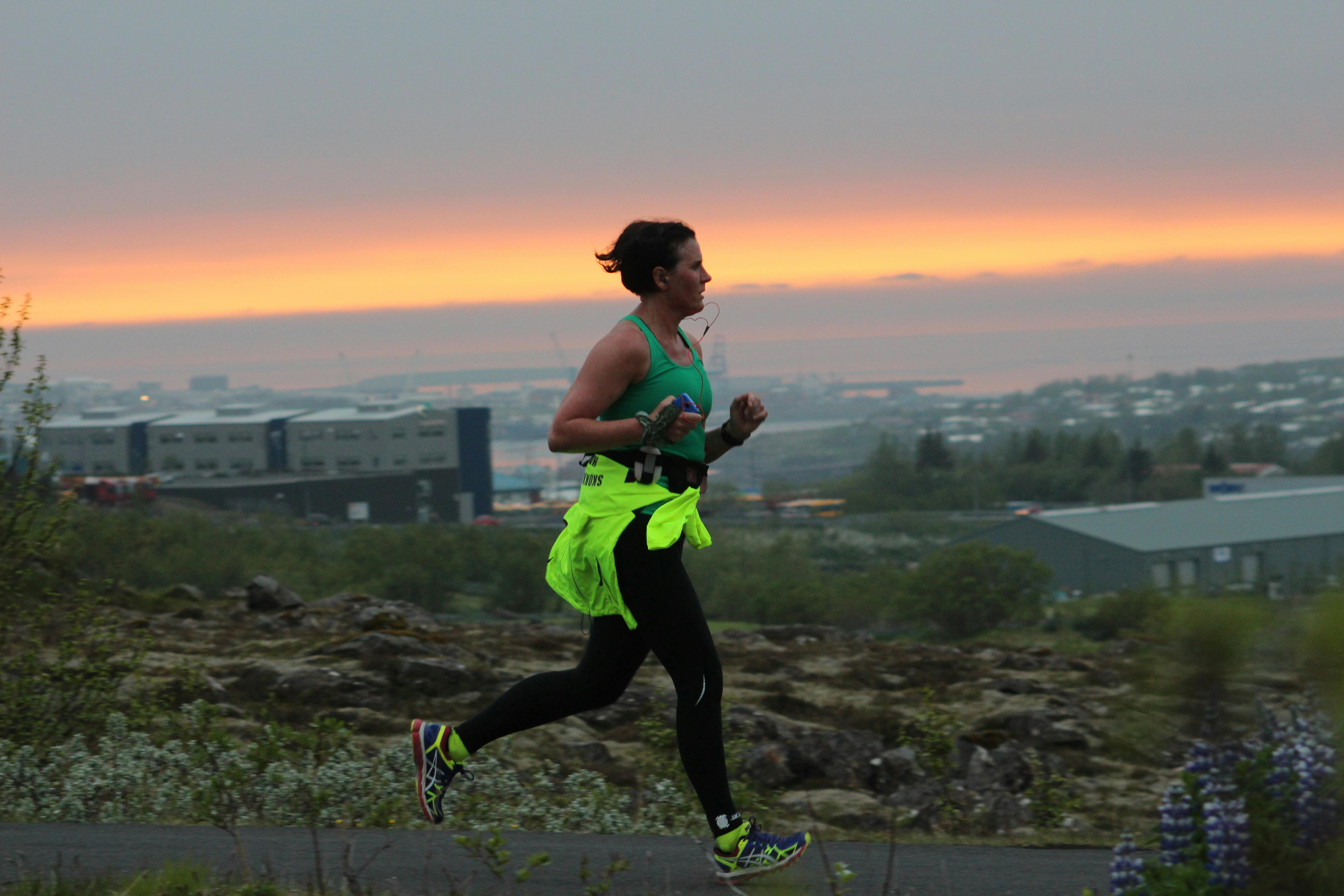 Woman running in the midnight sun