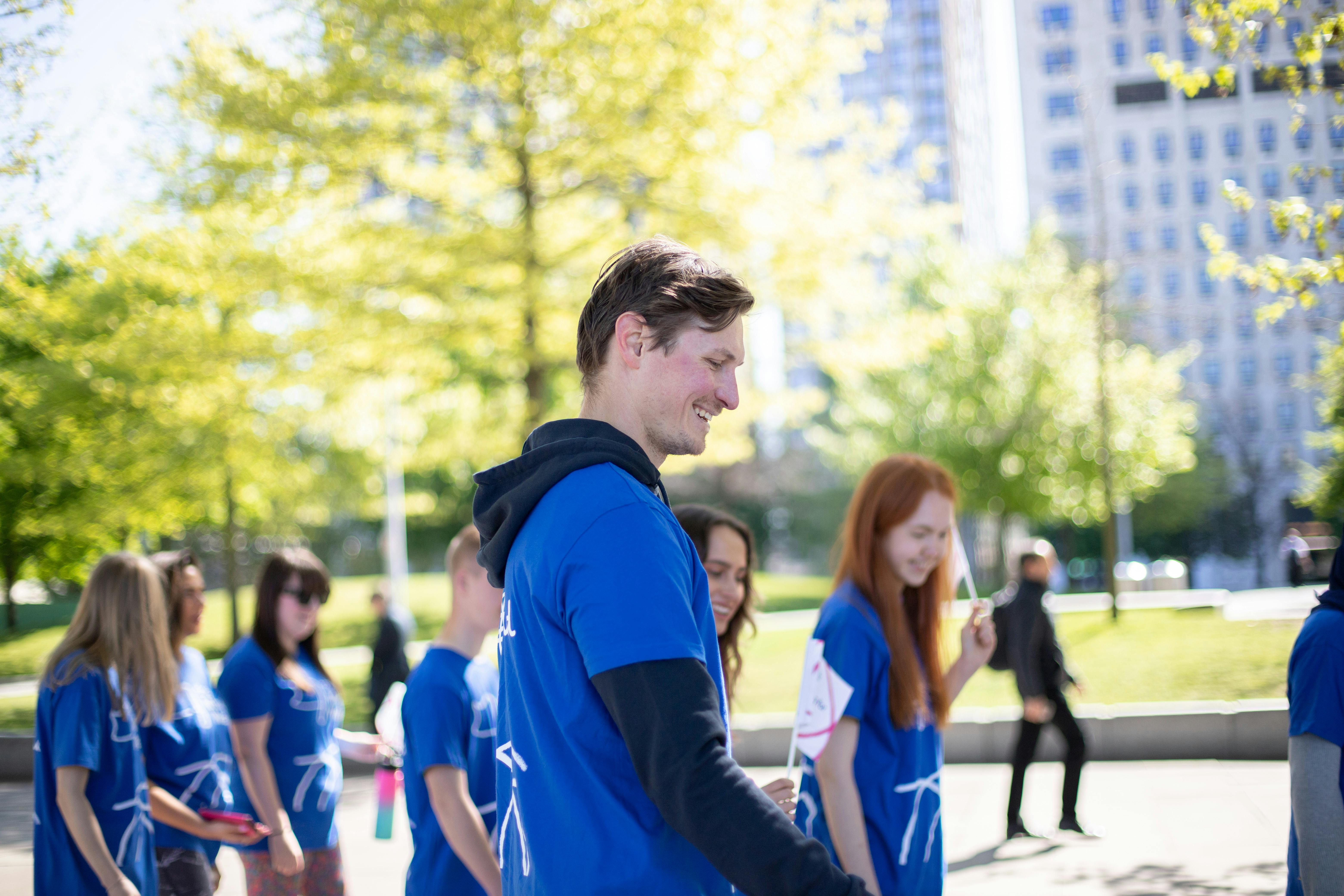Group of young adults smiling outside in their Mind t-shirts