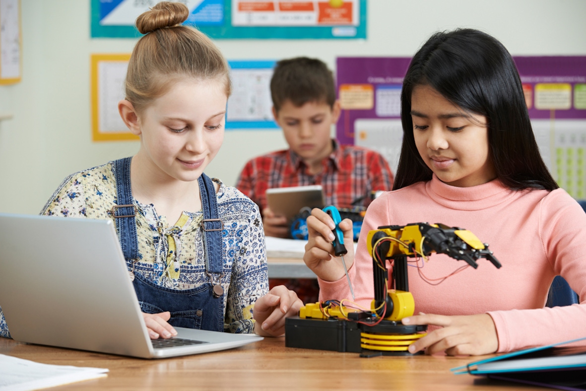 two children working on a robot
