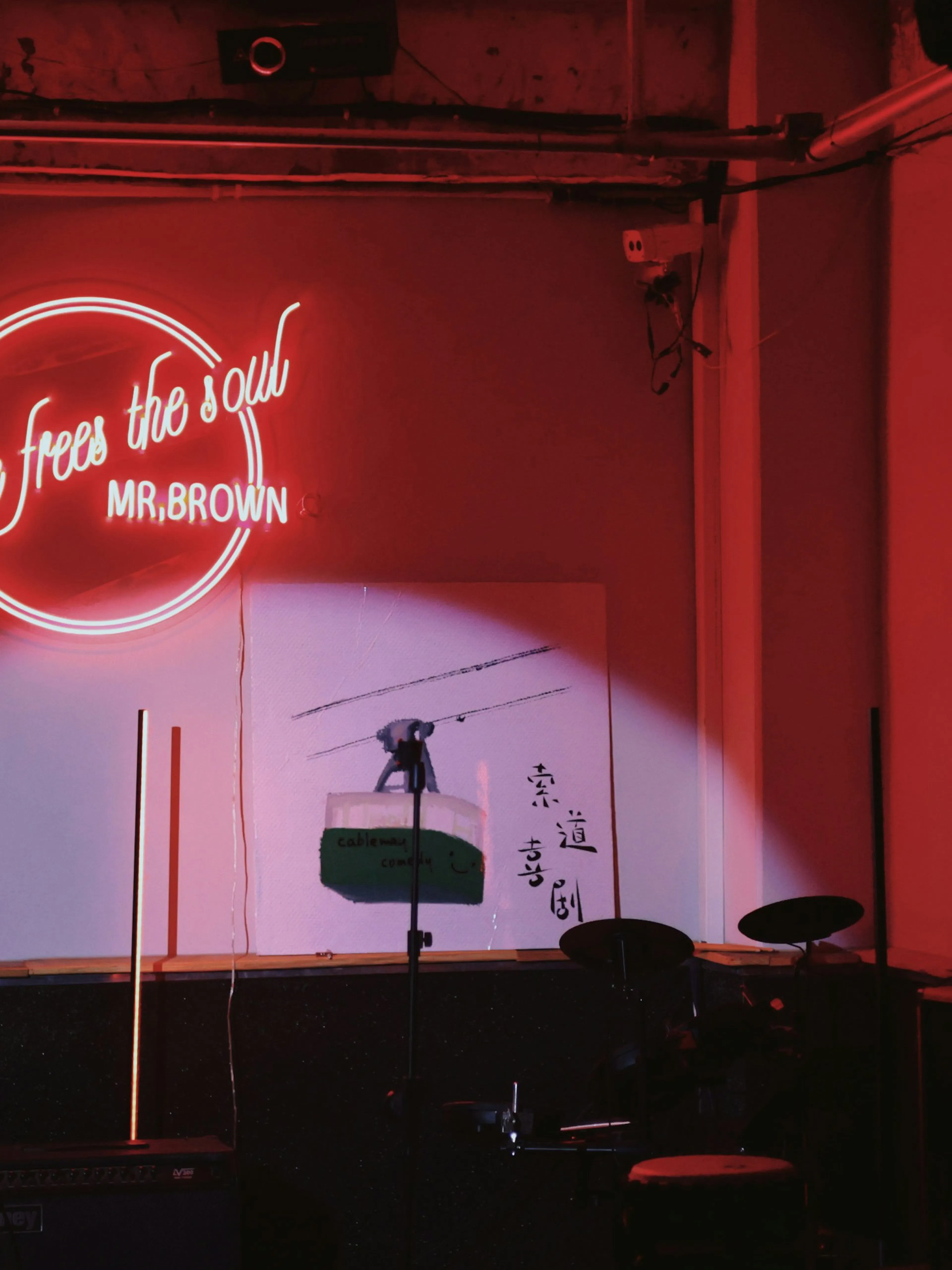 a stage set up for a concert with a neon sign