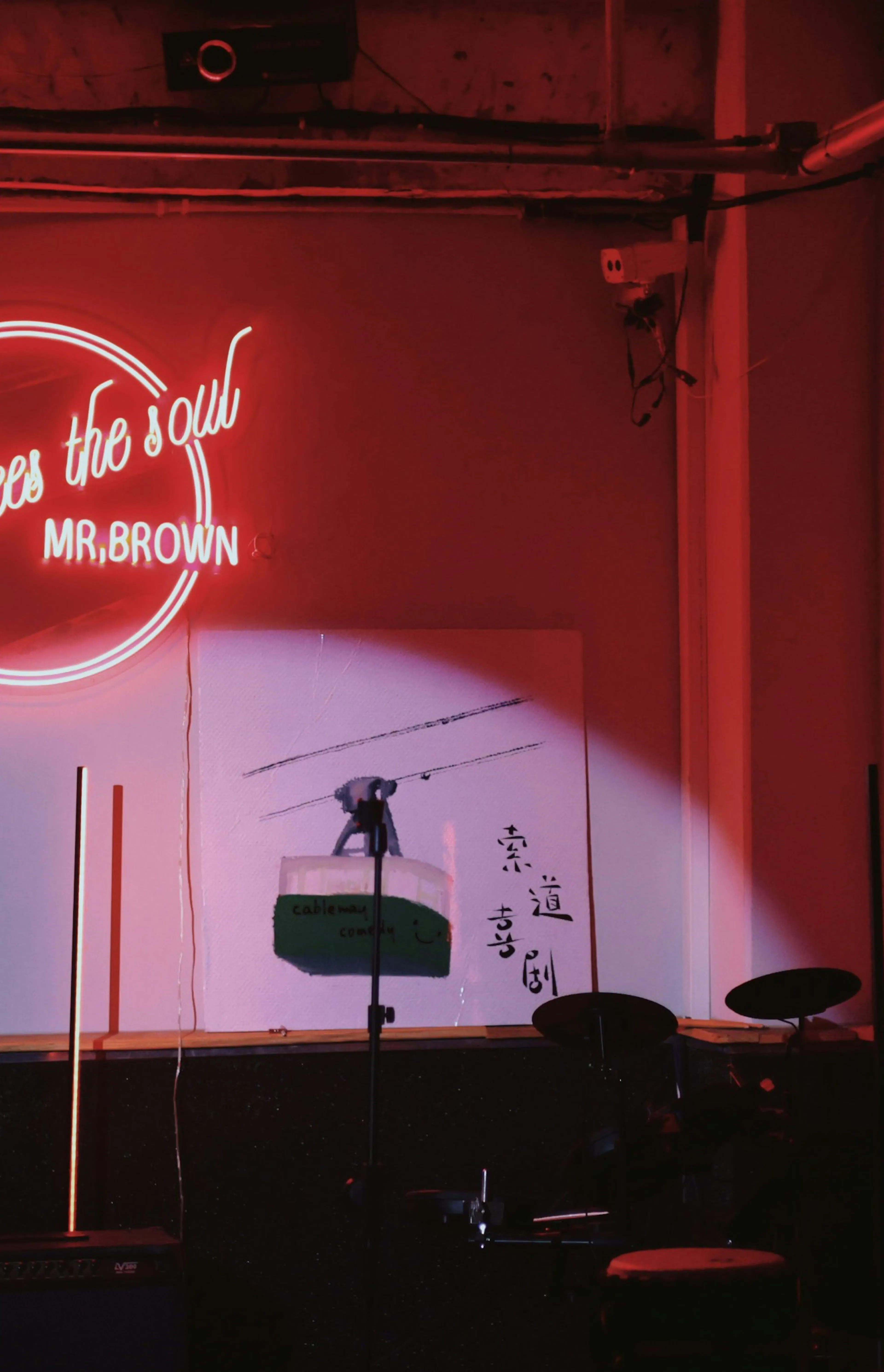 a stage set up for a concert with a neon sign