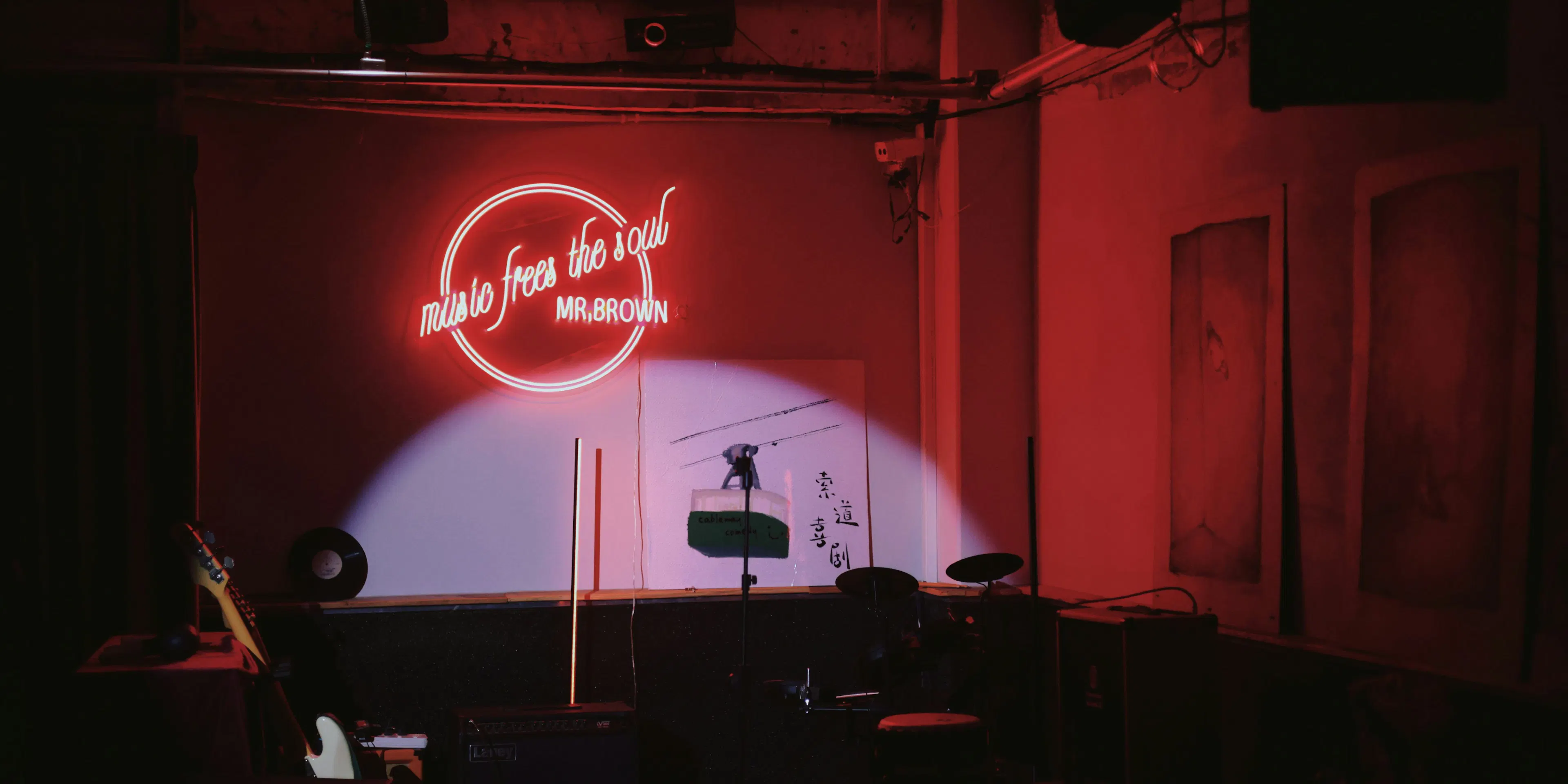 a stage set up for a concert with a neon sign