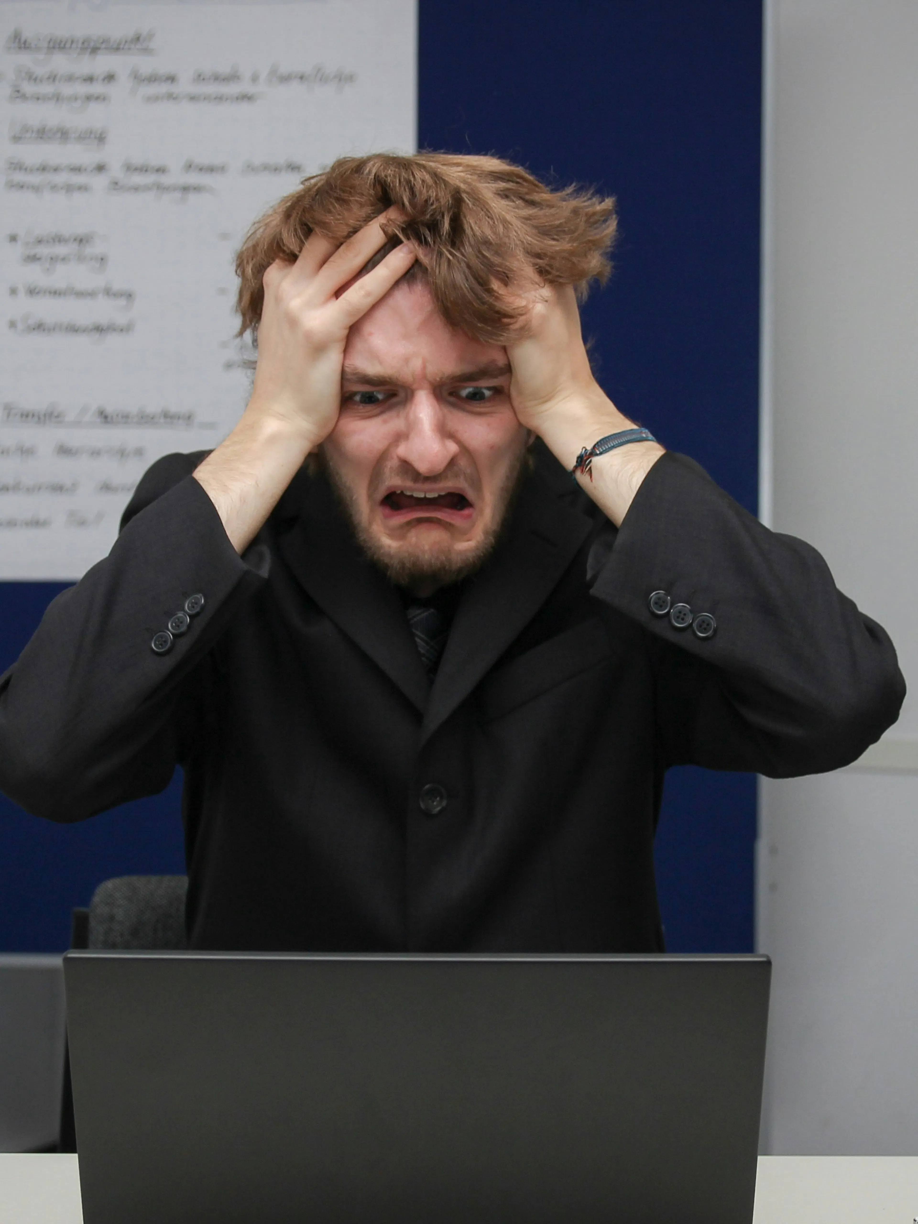 A man sitting in front of a laptop computer