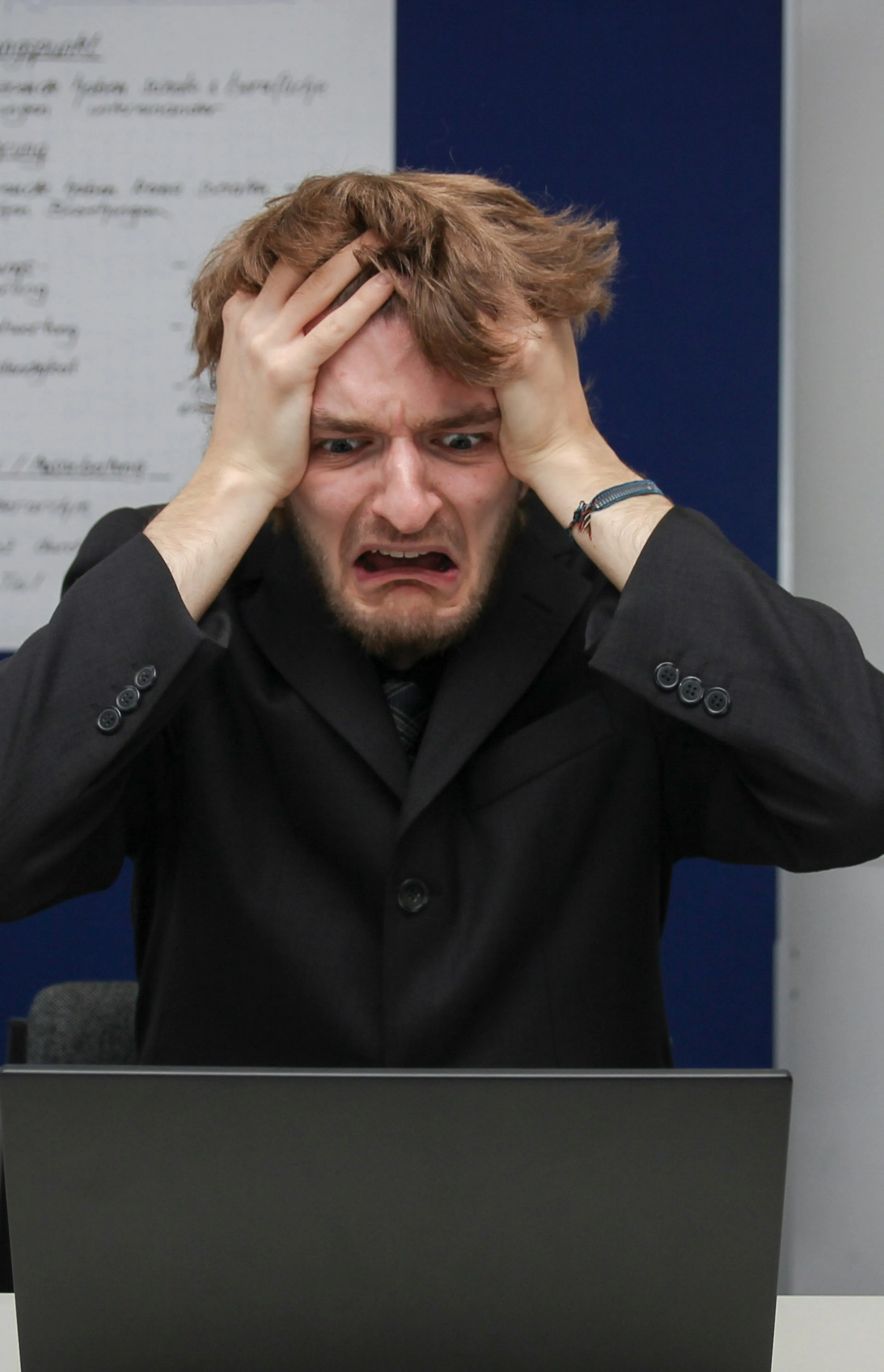 A man sitting in front of a laptop computer