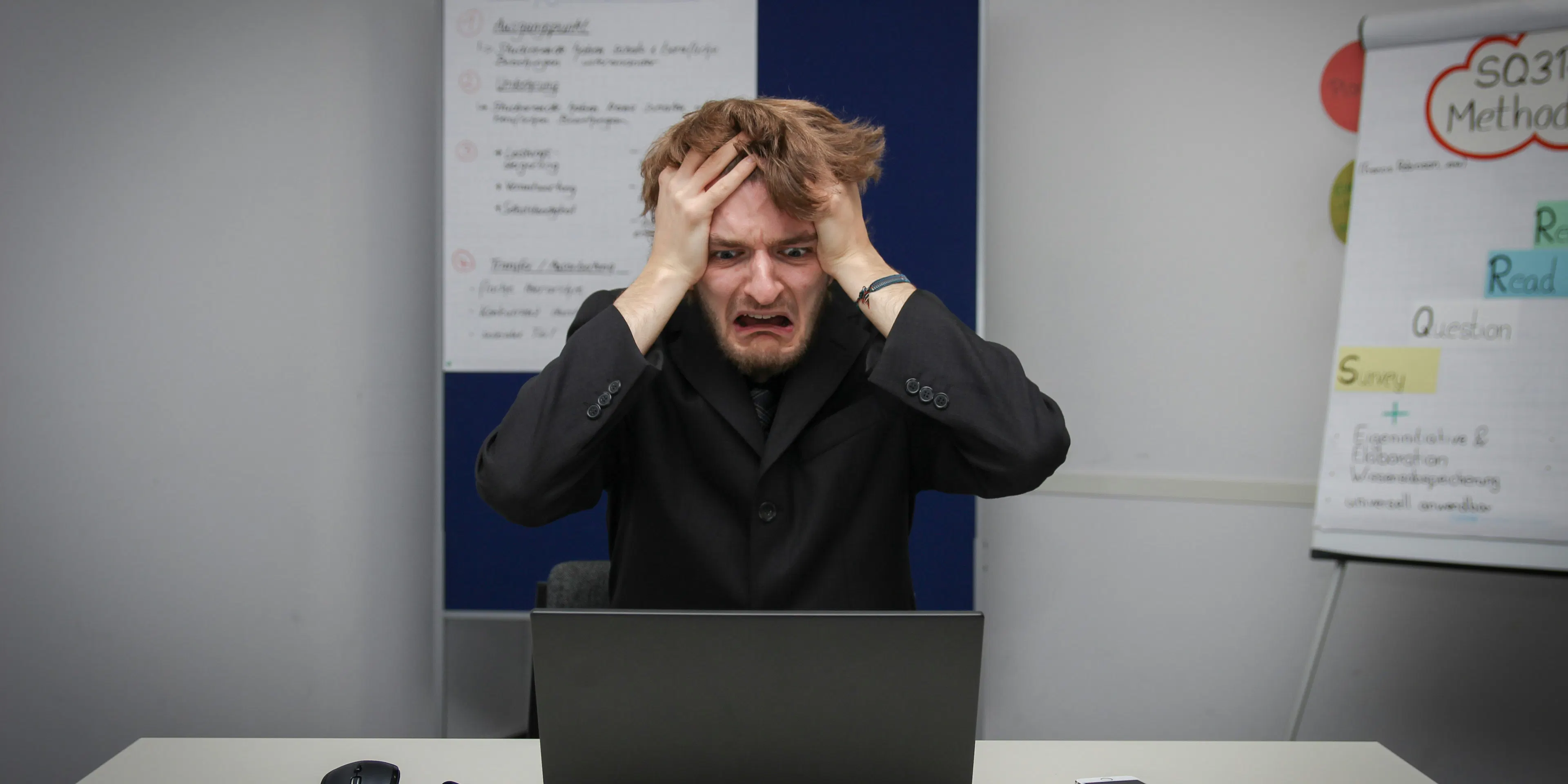 A man sitting in front of a laptop computer