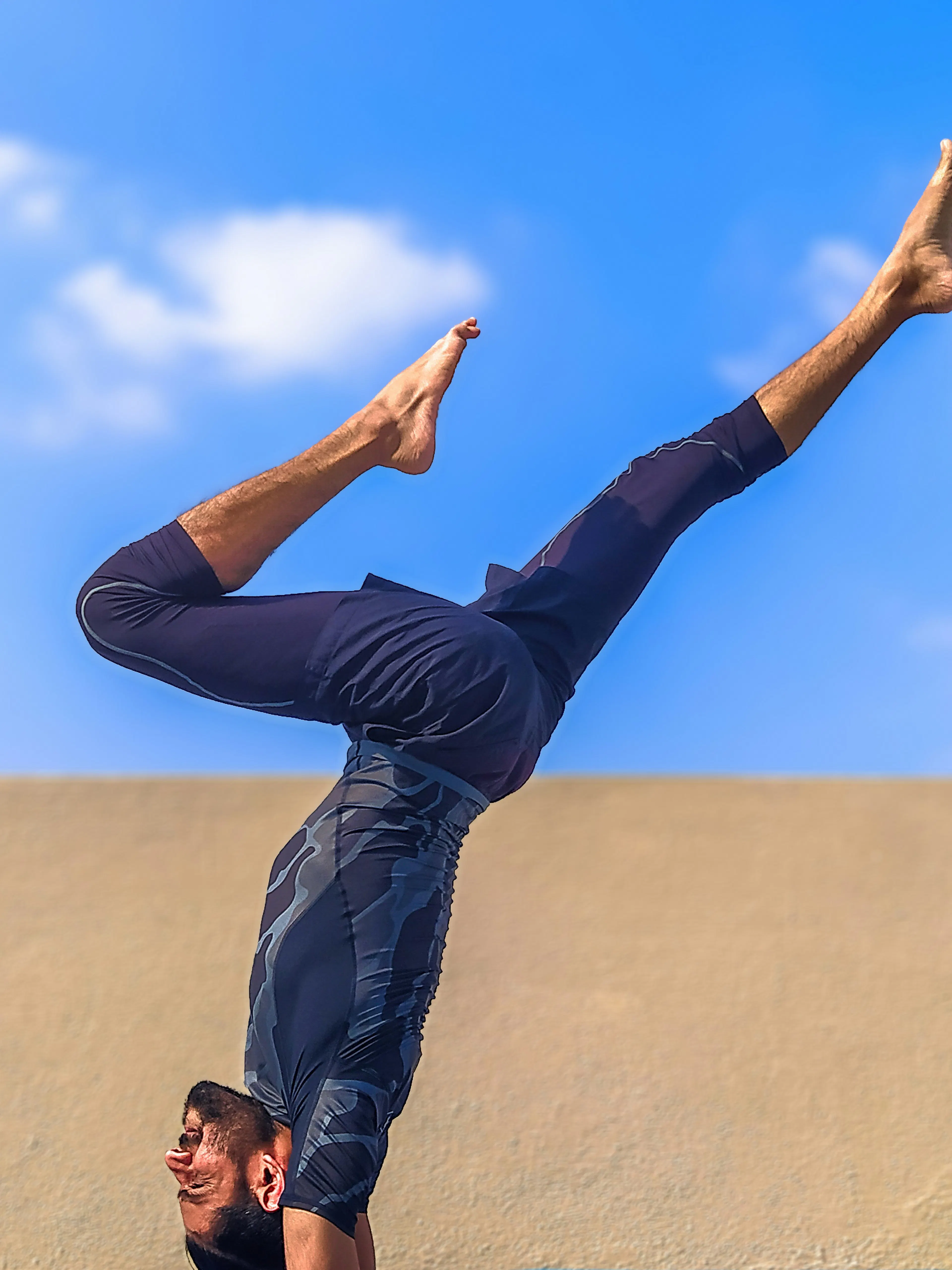 man in black pants and black shirt standing on blue yoga mat