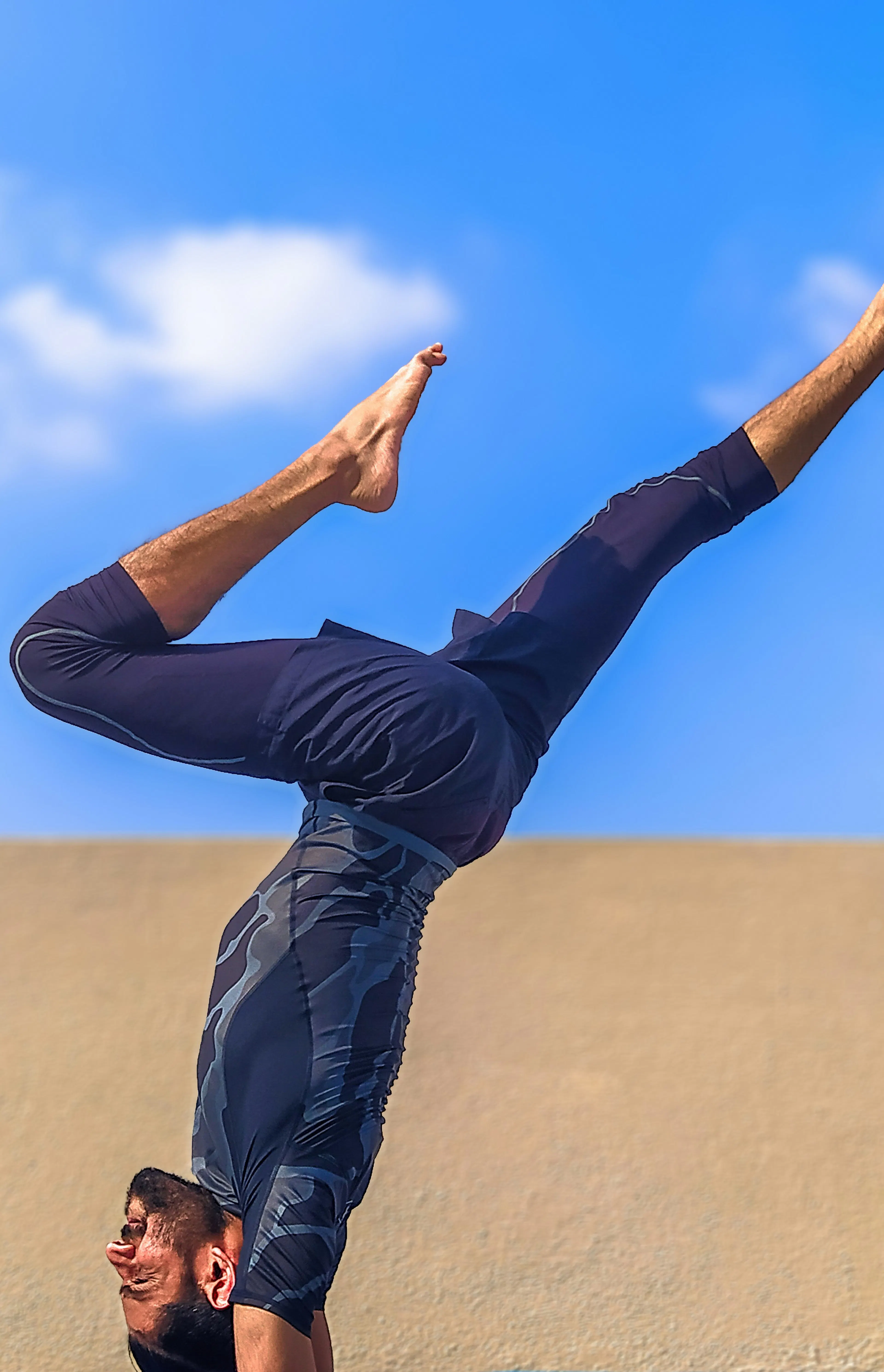man in black pants and black shirt standing on blue yoga mat