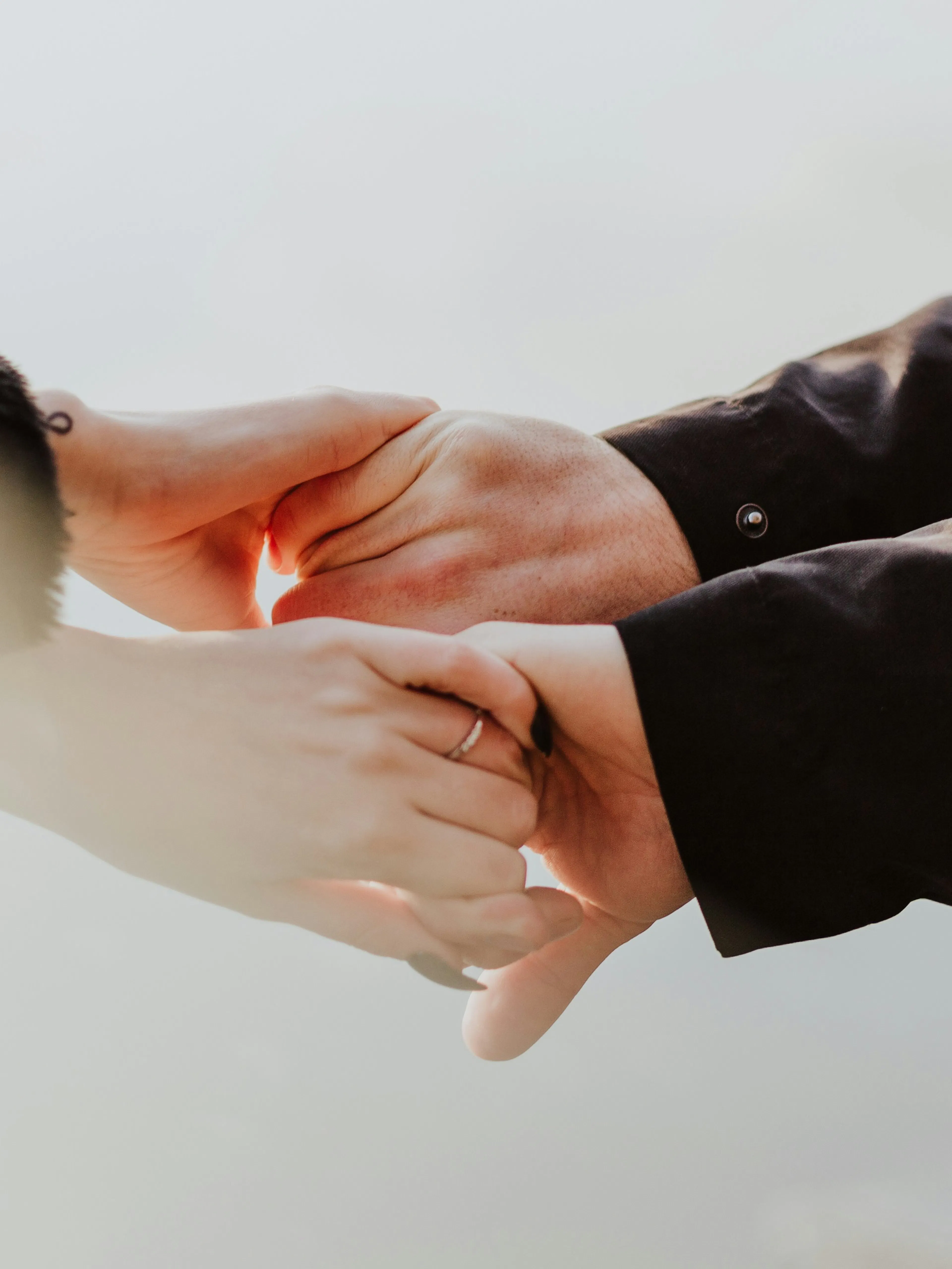 a couple holding hands while standing next to each other