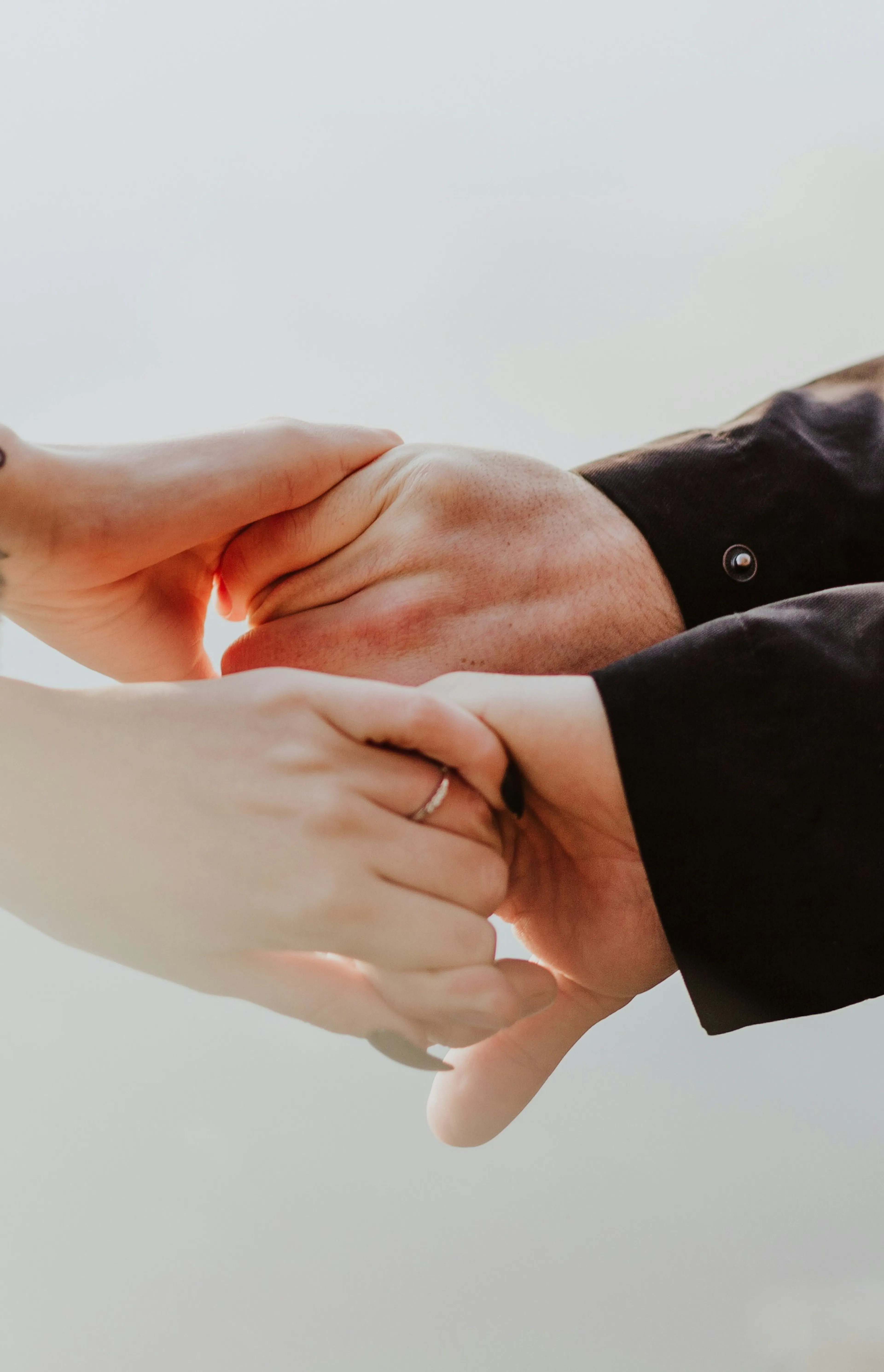 a couple holding hands while standing next to each other