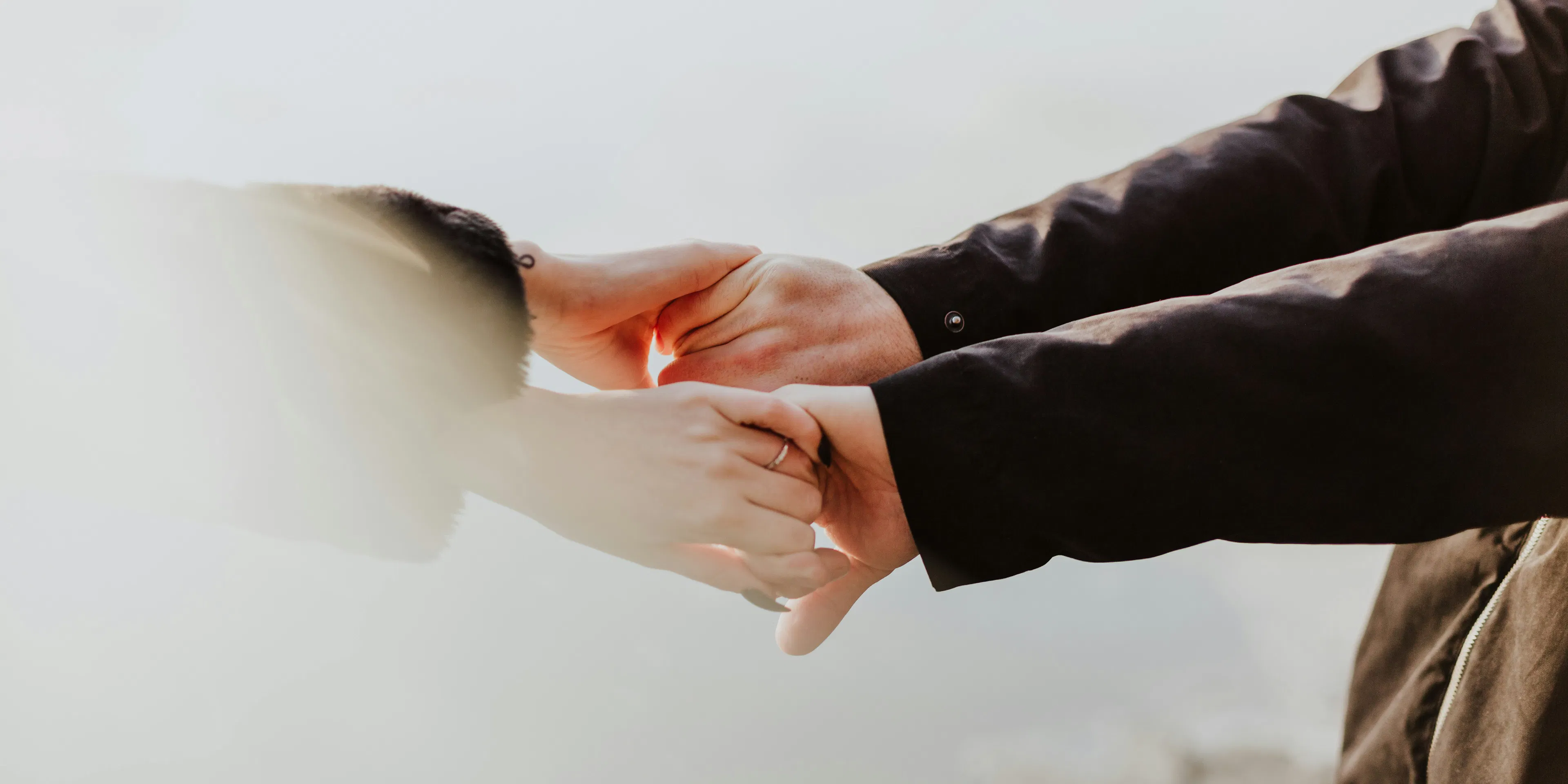 a couple holding hands while standing next to each other