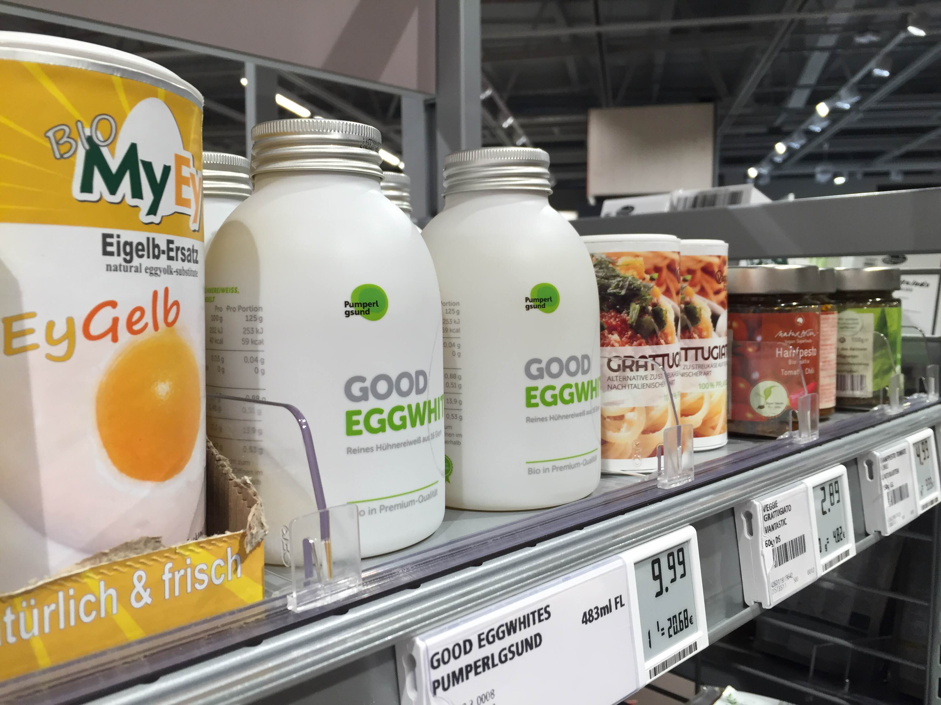 White branded bottles with good eggwhites from Pumperlgsund shown on supermarket shelf next to spicery