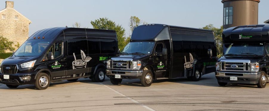 Mint Julep Experiences' fleet of luxury tour vehicles, each featuring the company logo.