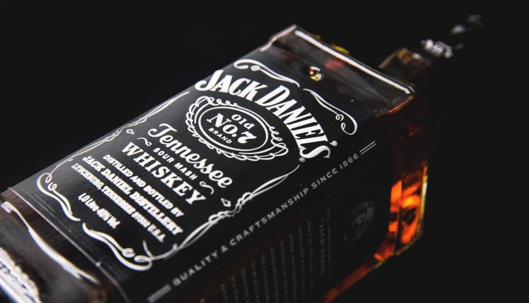 A bottle of Jack Daniel's Tennessee Whiskey against a dark background.