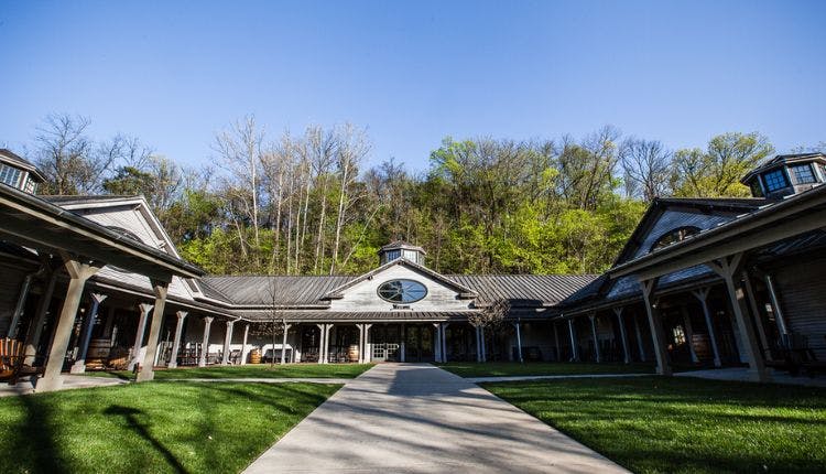 An exterior view of the Jack Daniel's Visitor Center, showcasing its welcoming entrance and rustic design.