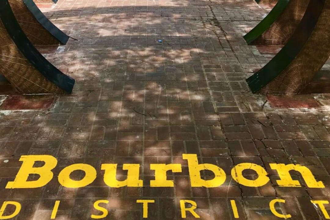 Louisville's Bourbon District featuring the distinctive yellow "Bourbon District" lettering painted on the pavement.