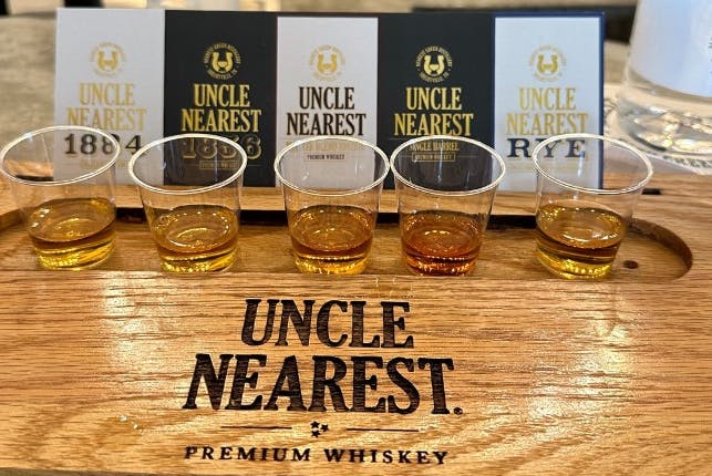 A set of glasses filled with Uncle Nearest Premium Whiskey samples, ready for tasting.